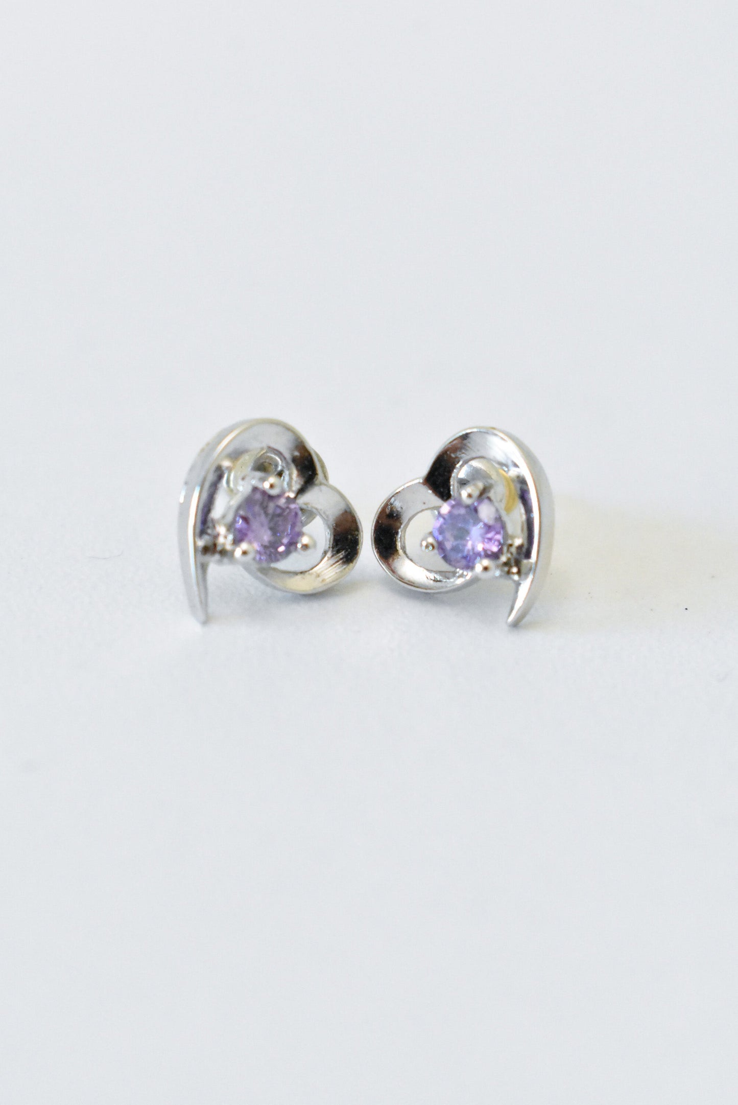 Silver heart earrings with purple gemstones