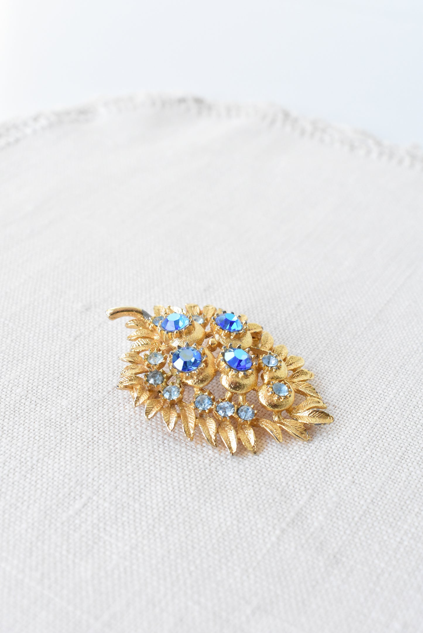 Vintage golden + blue gems brooch