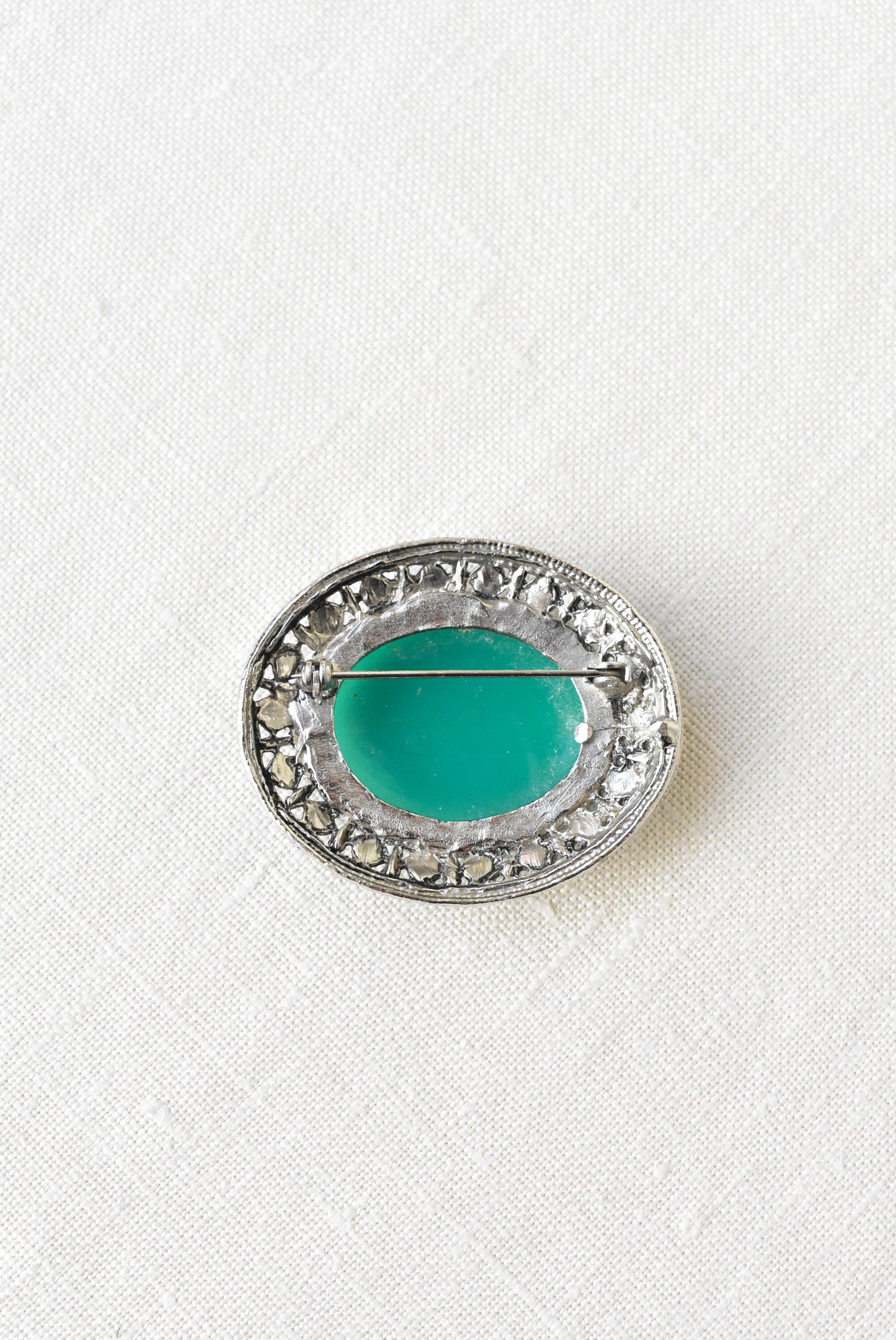 Silver and emerald brooch