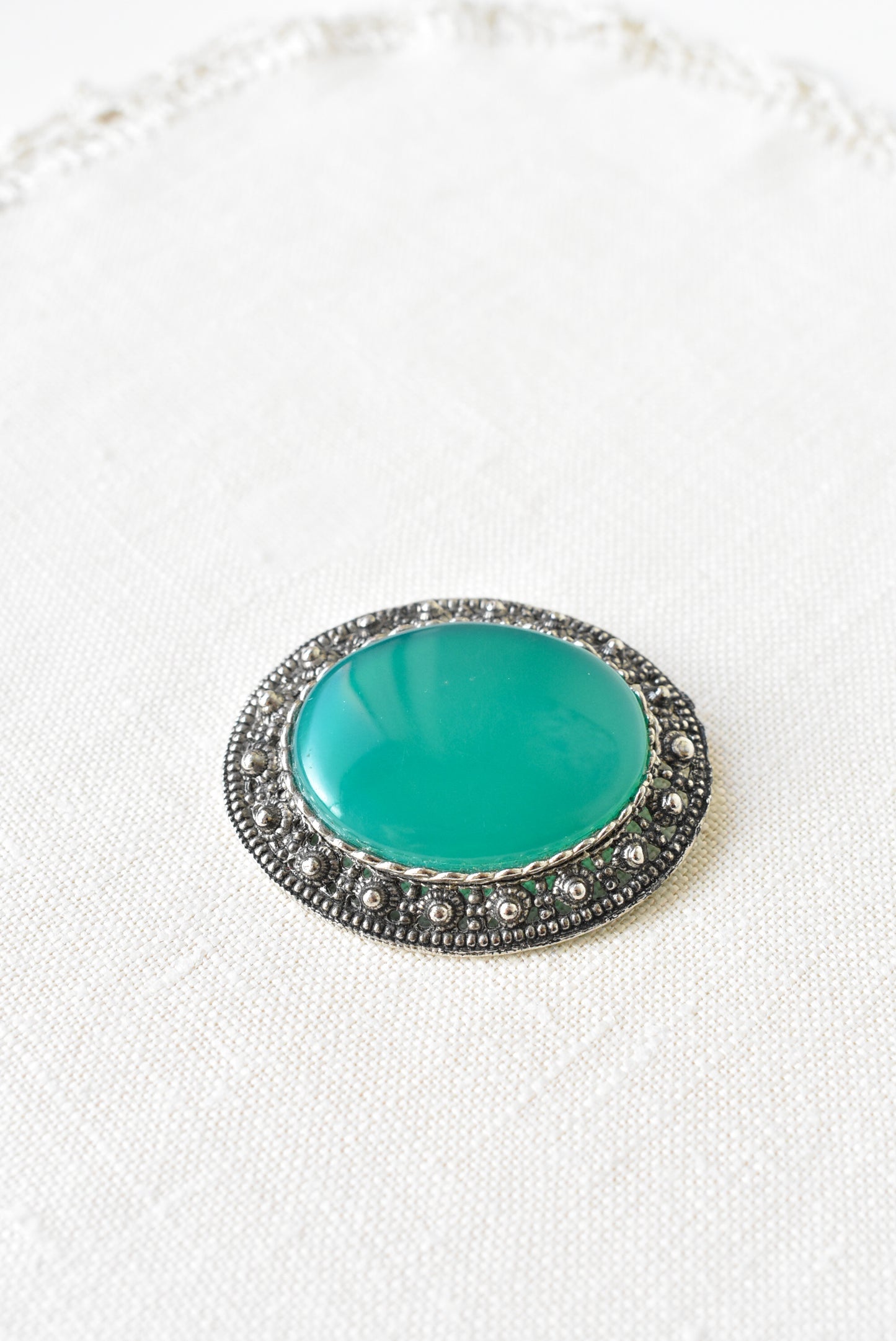 Silver and emerald brooch