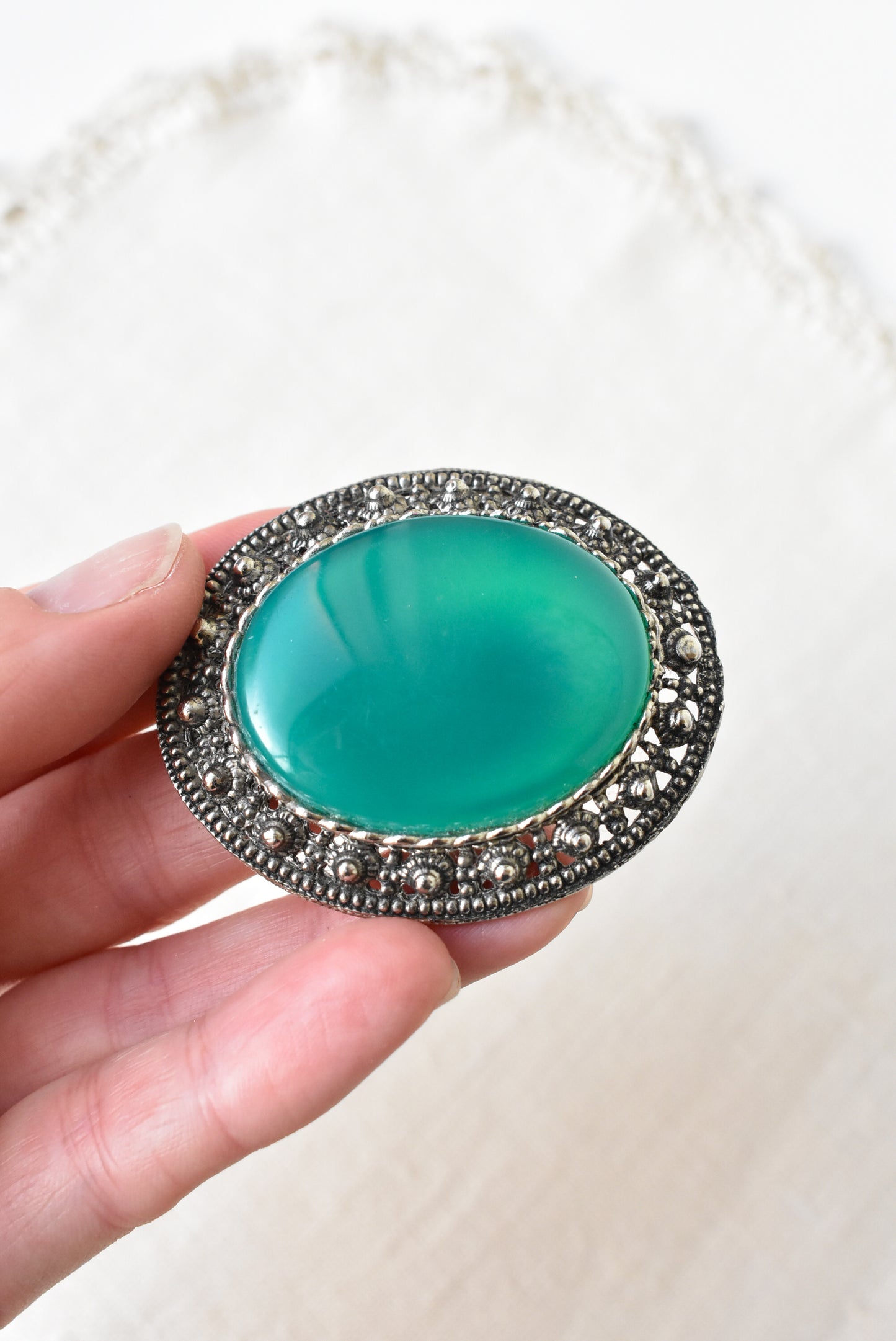 Silver and emerald brooch