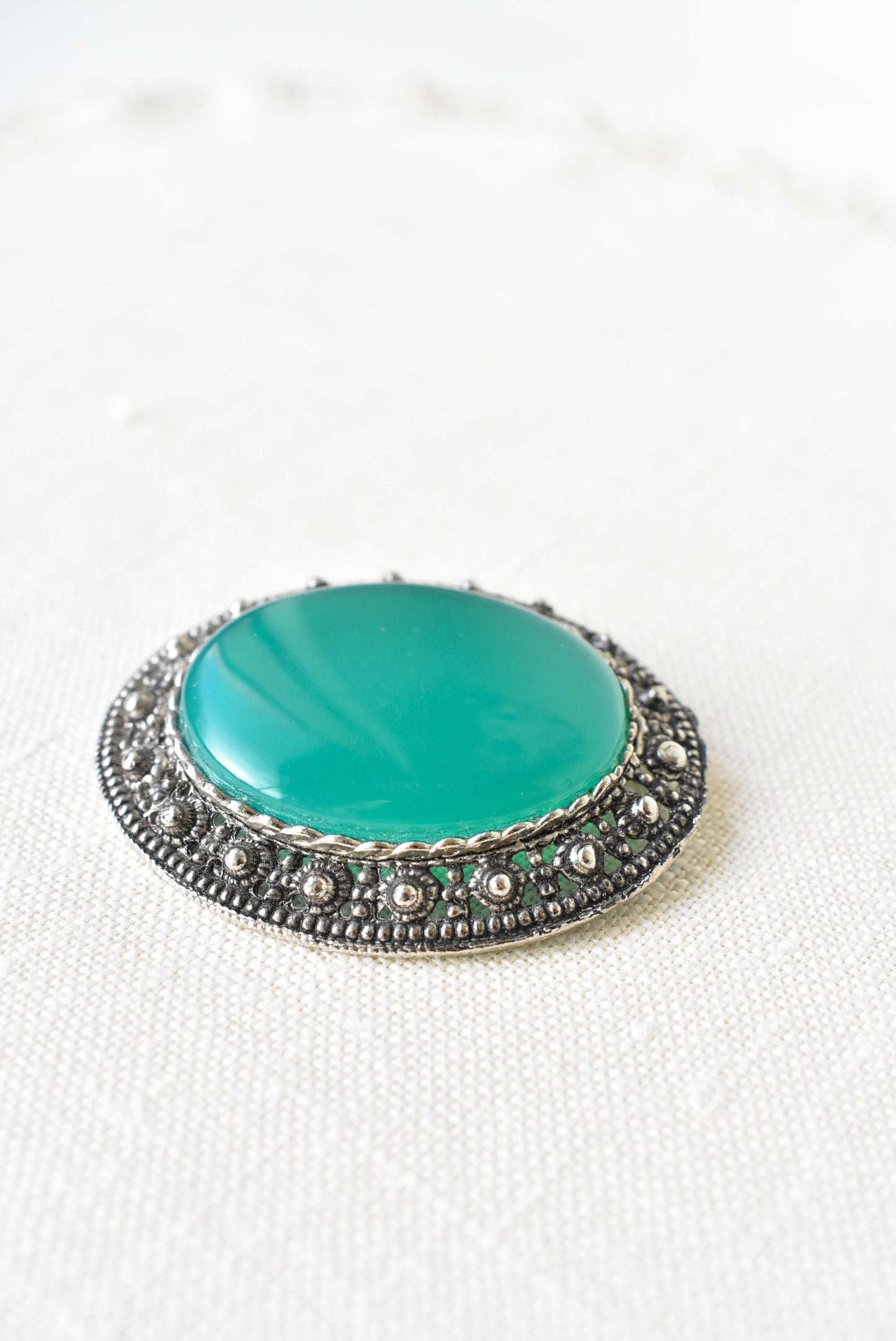 Silver and emerald brooch