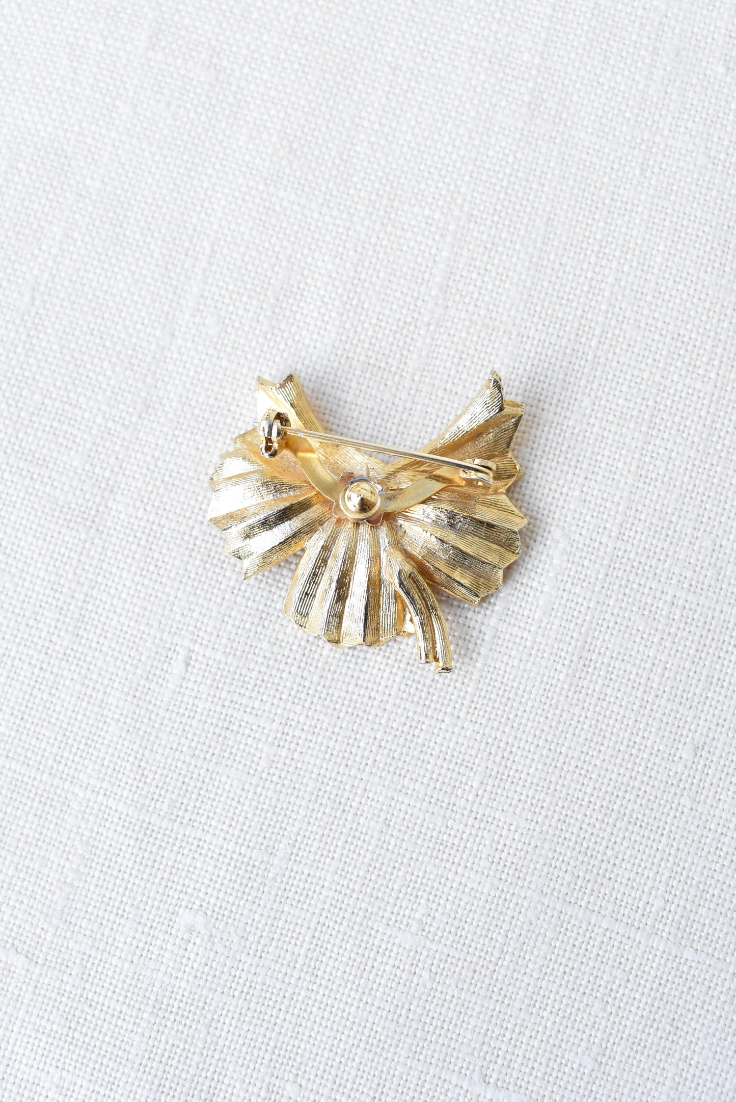 Golden bow brooch