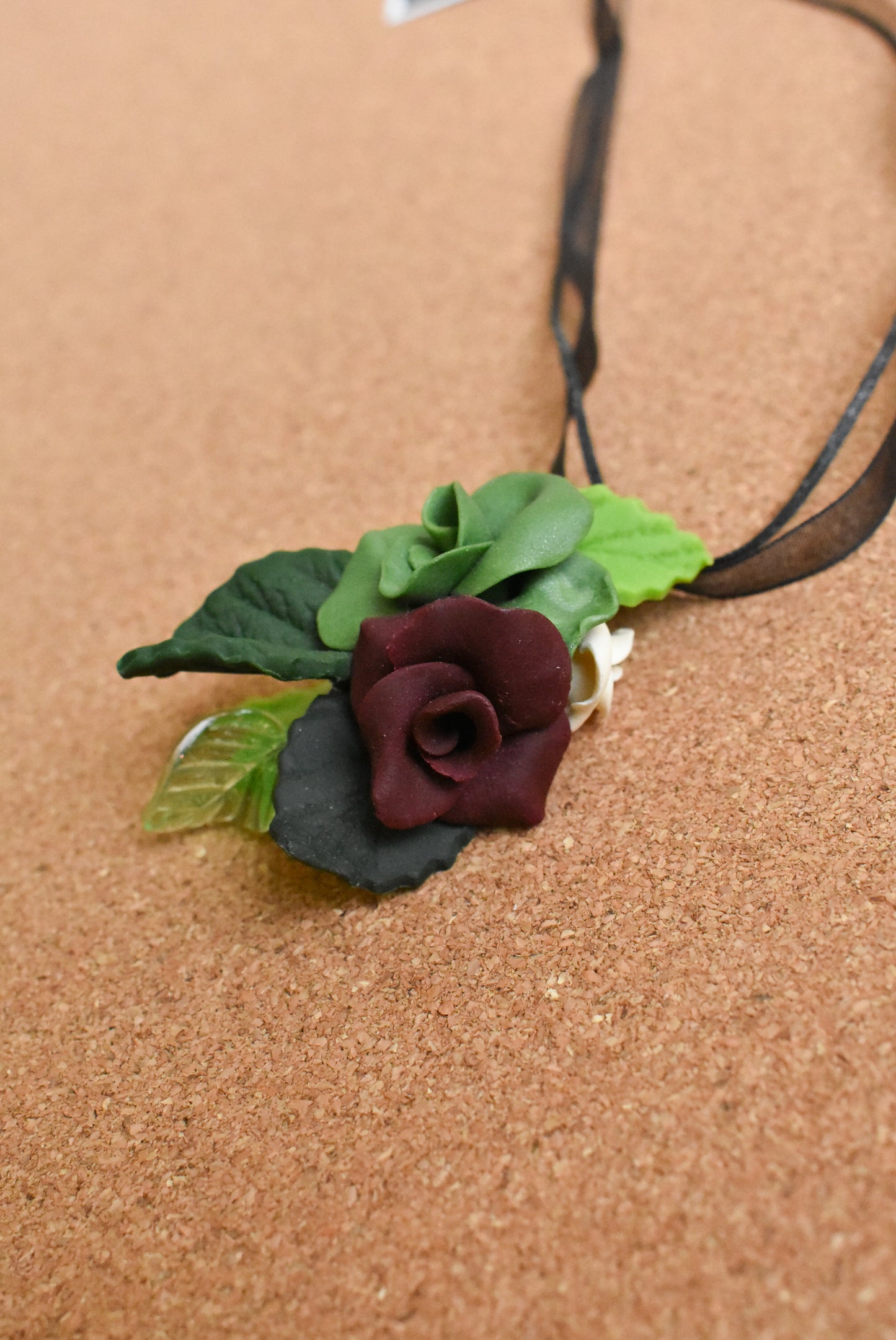 Ceramic flower ribbon necklace with green and purple flowers
