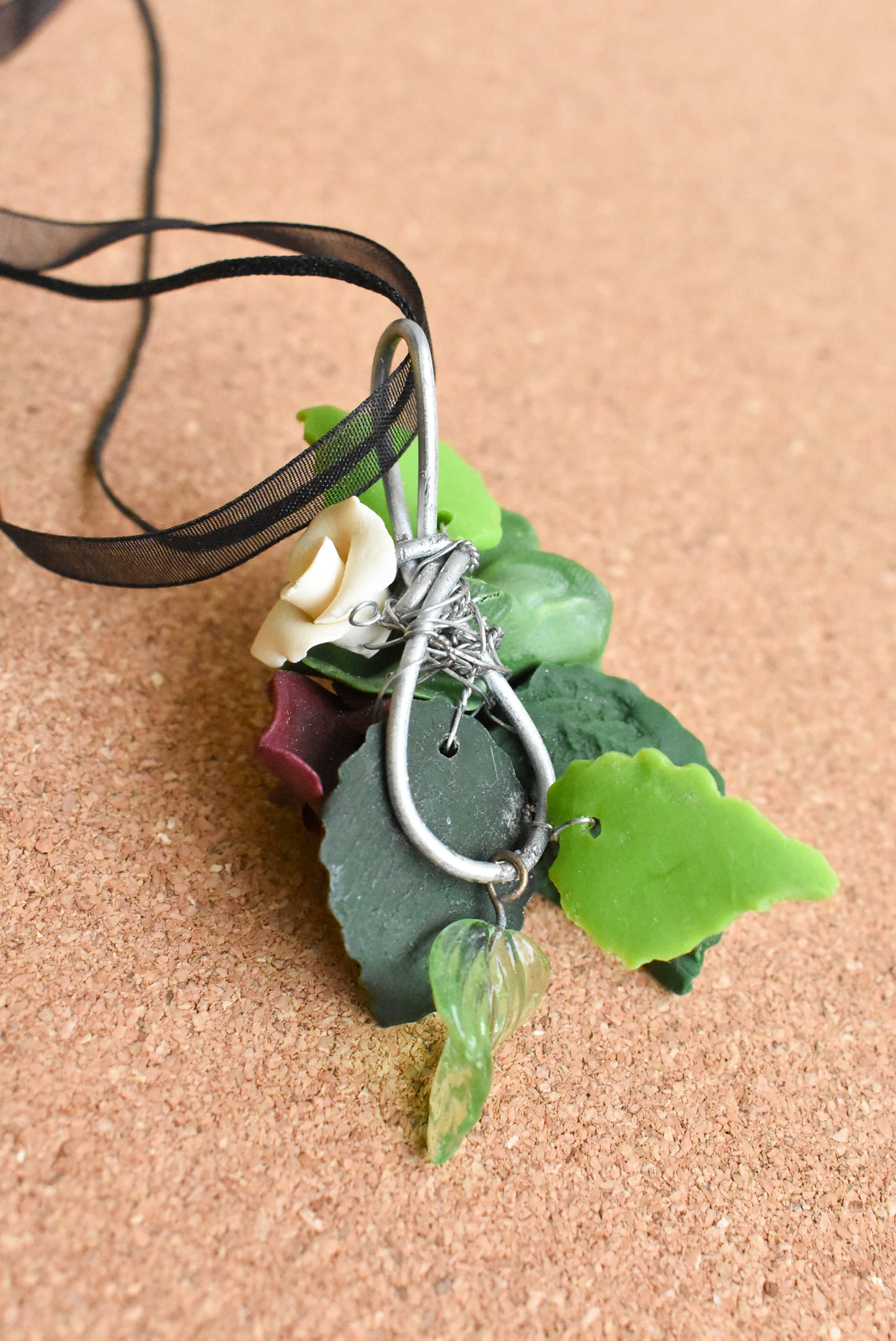 Ceramic flower ribbon necklace with green and purple flowers