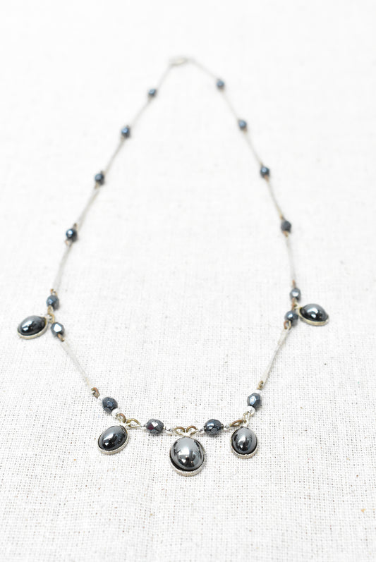 Necklace with dark droplets