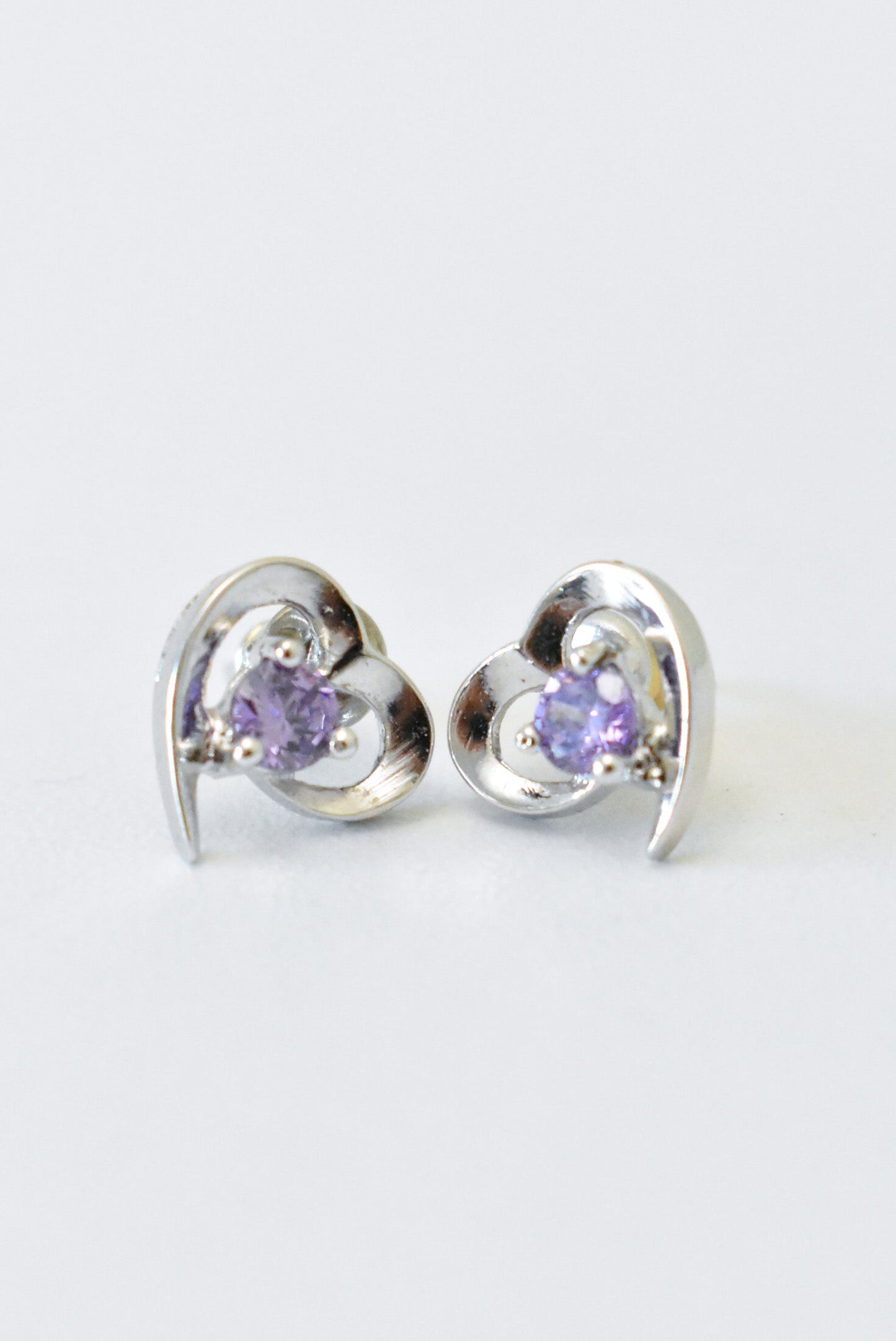 Silver heart earrings with purple gemstones