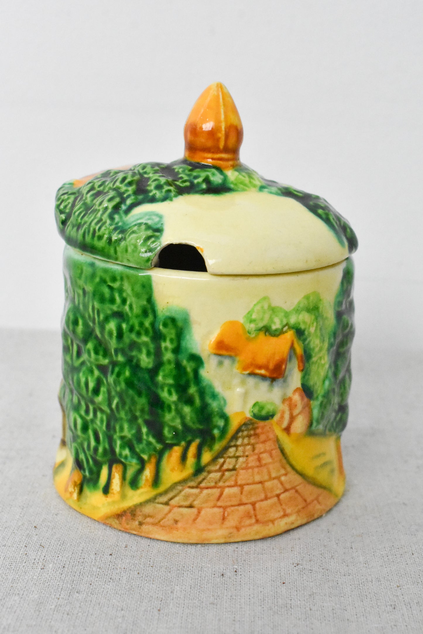 Vintage jam pot depicting English countryside