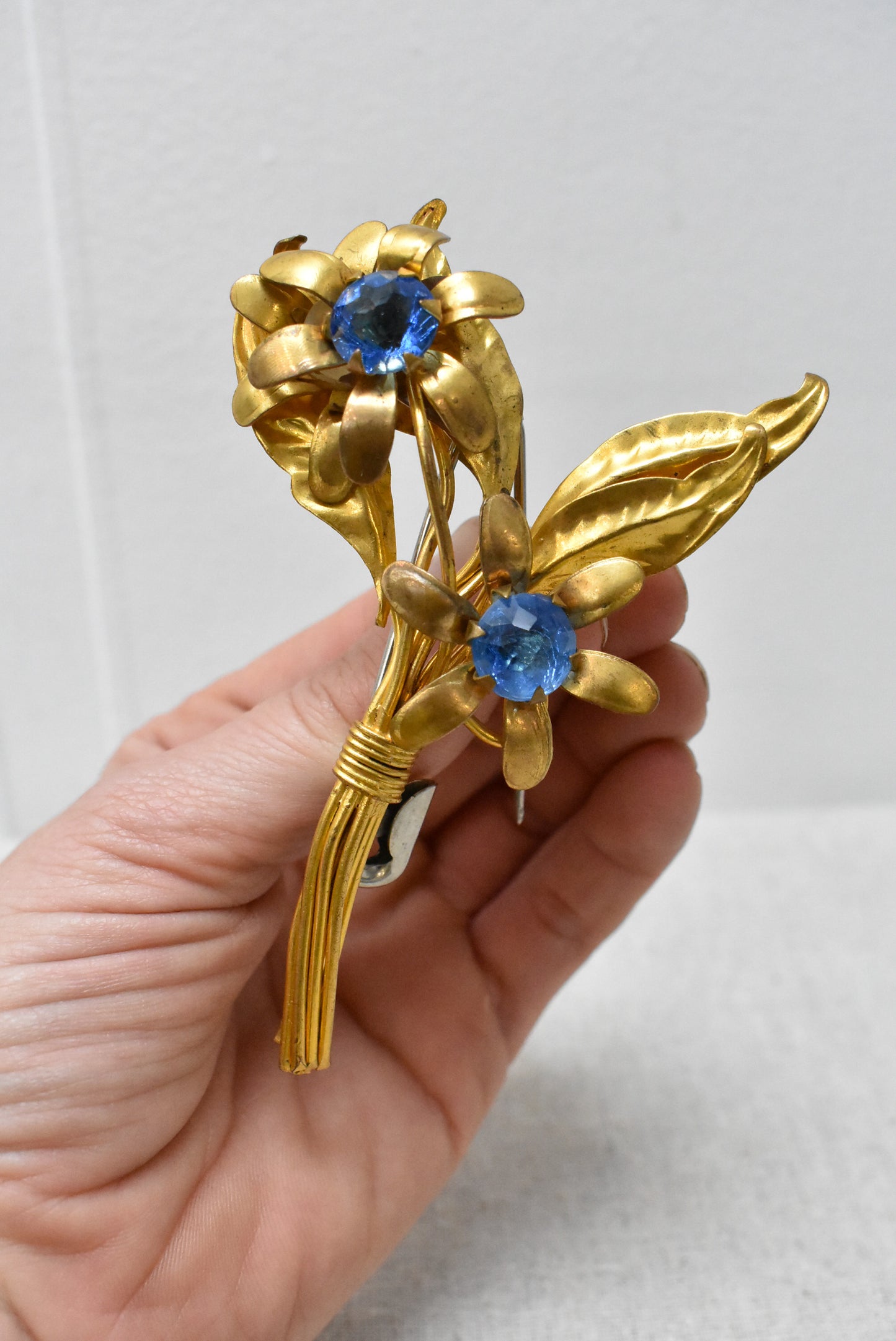 Floral brooch with blue gems