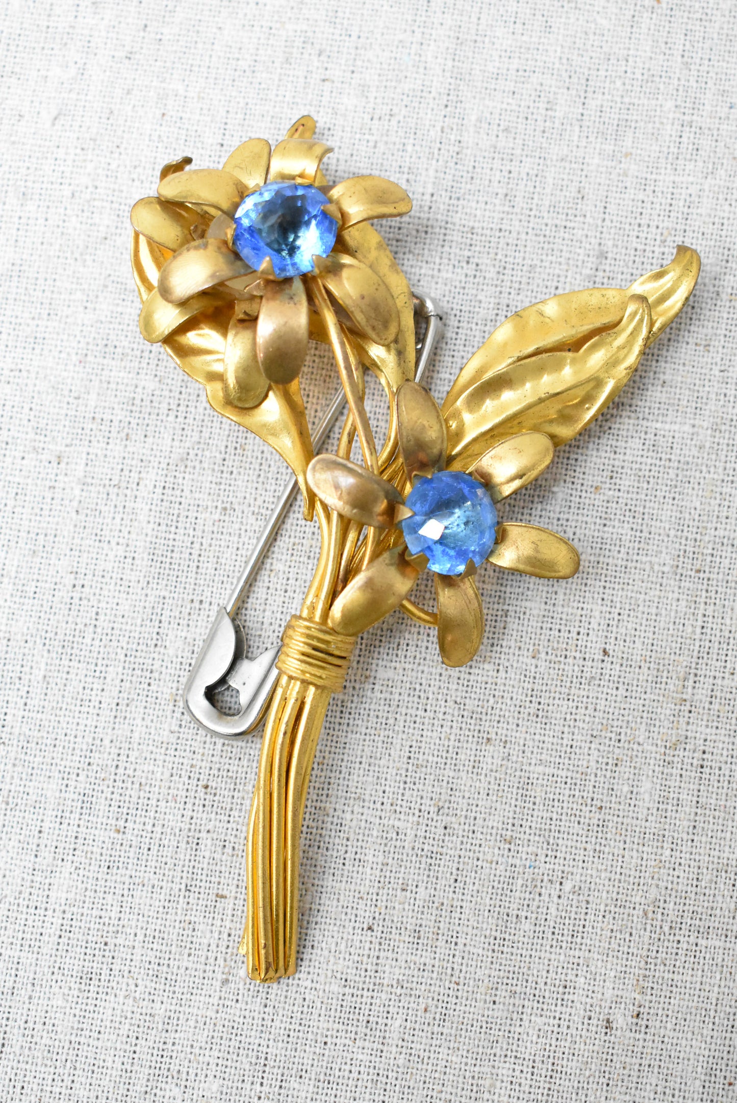 Floral brooch with blue gems