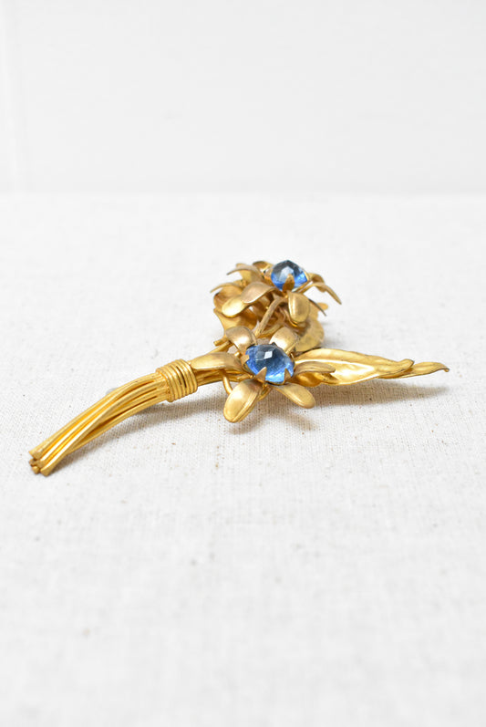 Floral brooch with blue gems