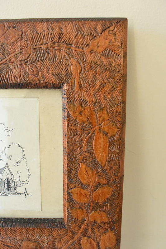 Two pen and ink sketches in an ornately hand carved frame