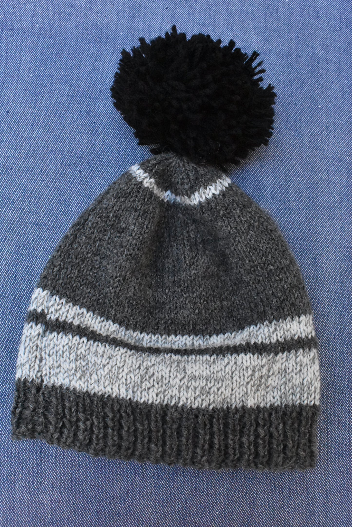 Childs knitted hat with pom pom