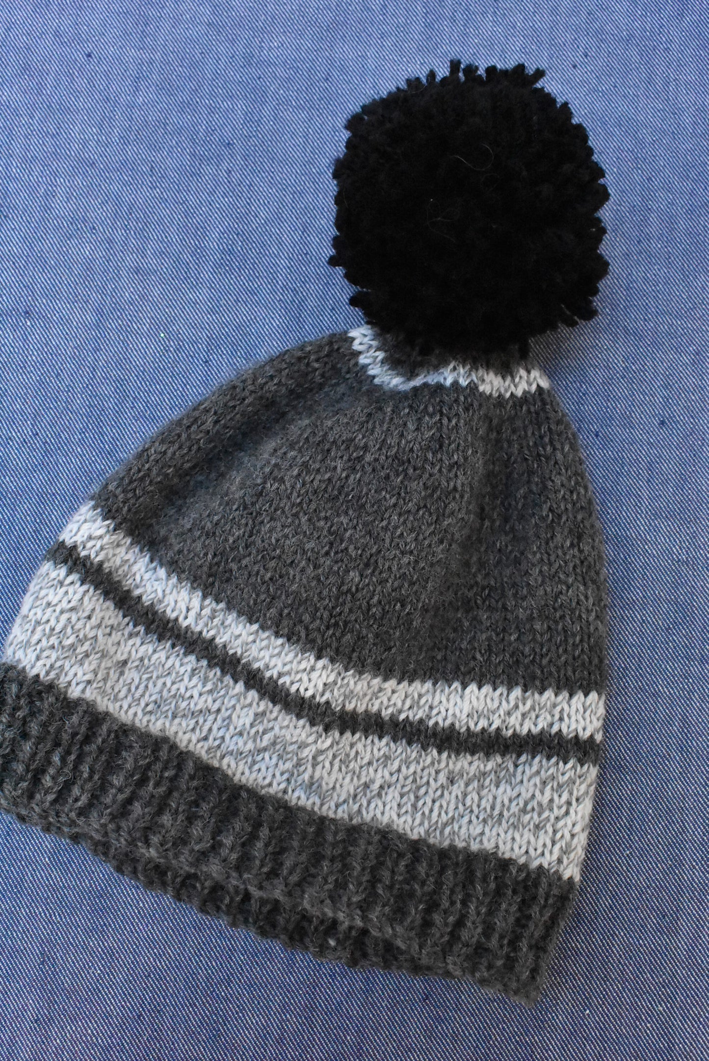 Childs knitted hat with pom pom