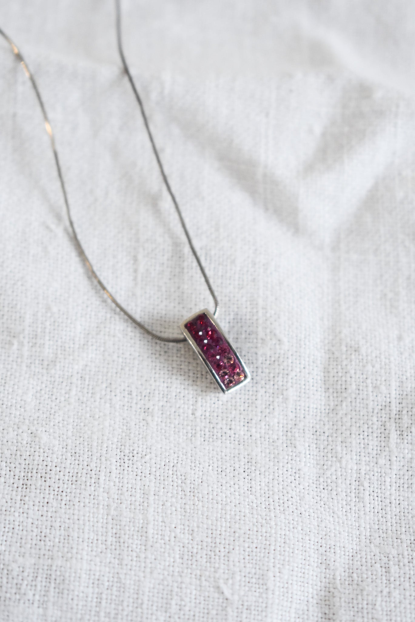 Pink sparkly pendant on silver chain