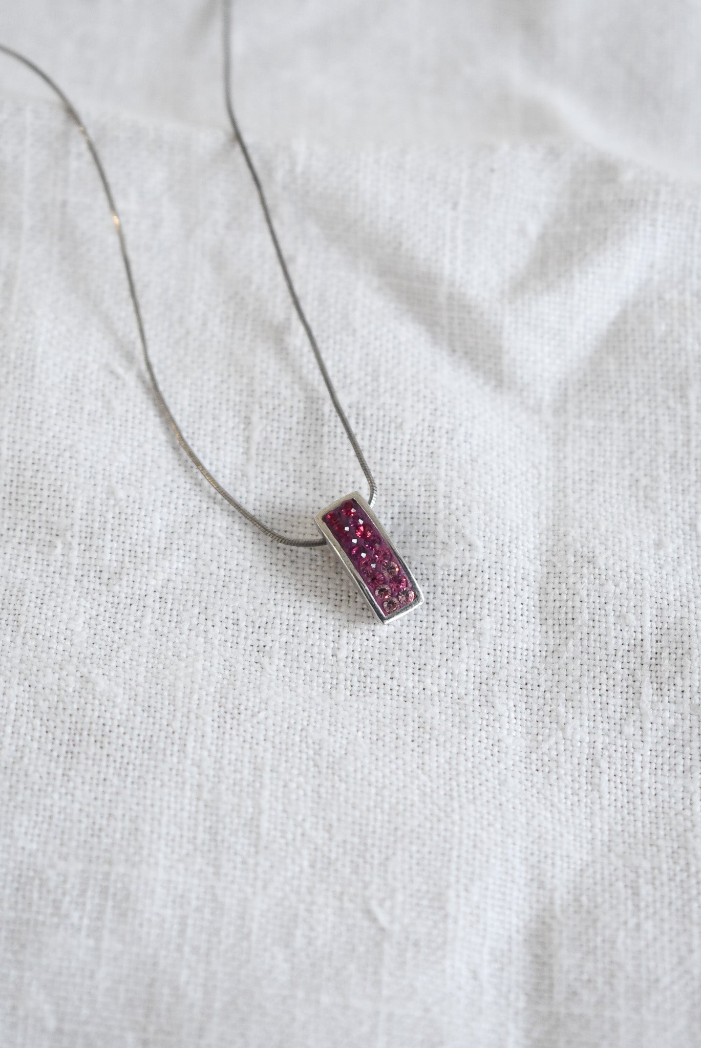 Pink sparkly pendant on silver chain