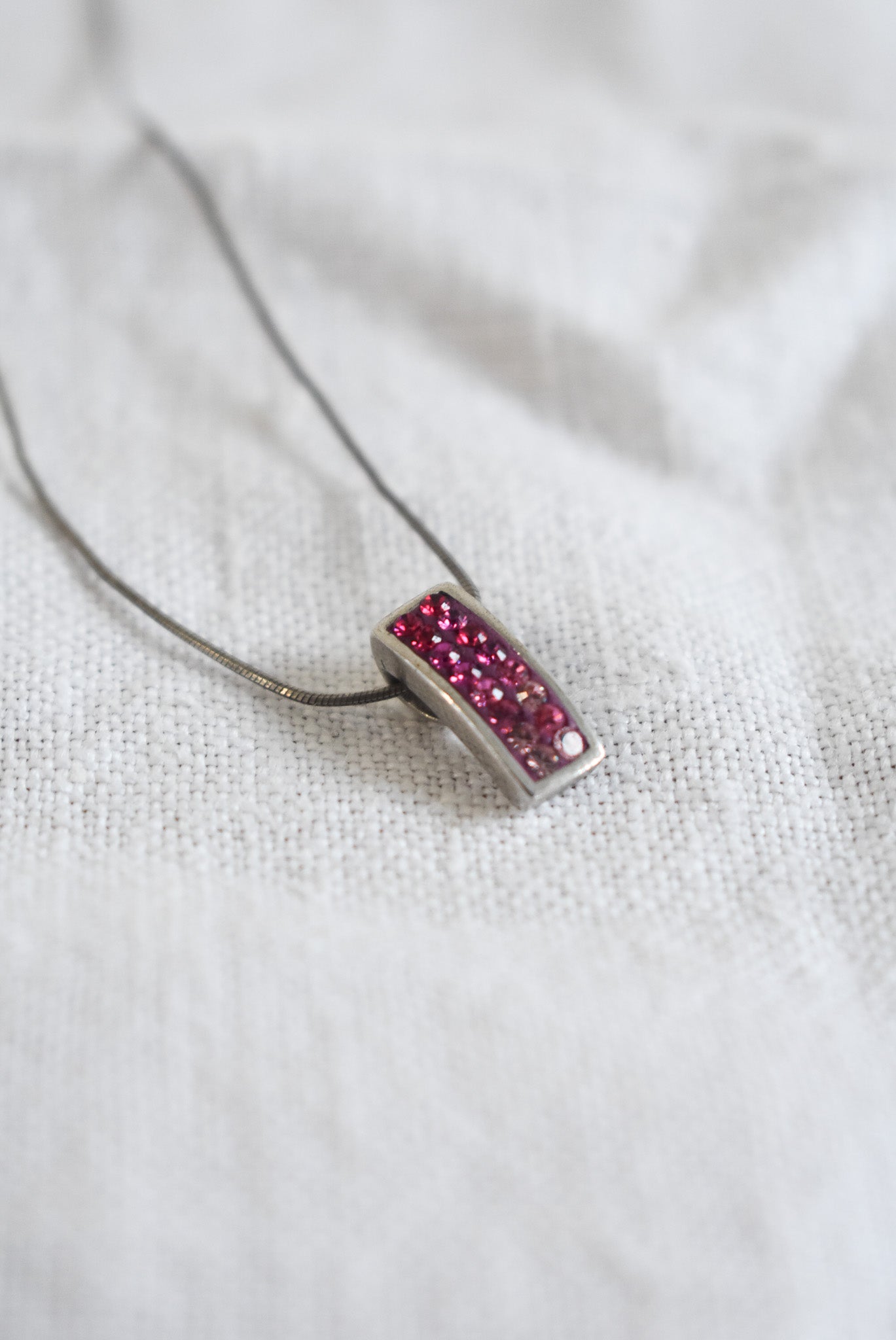 Pink sparkly pendant on silver chain