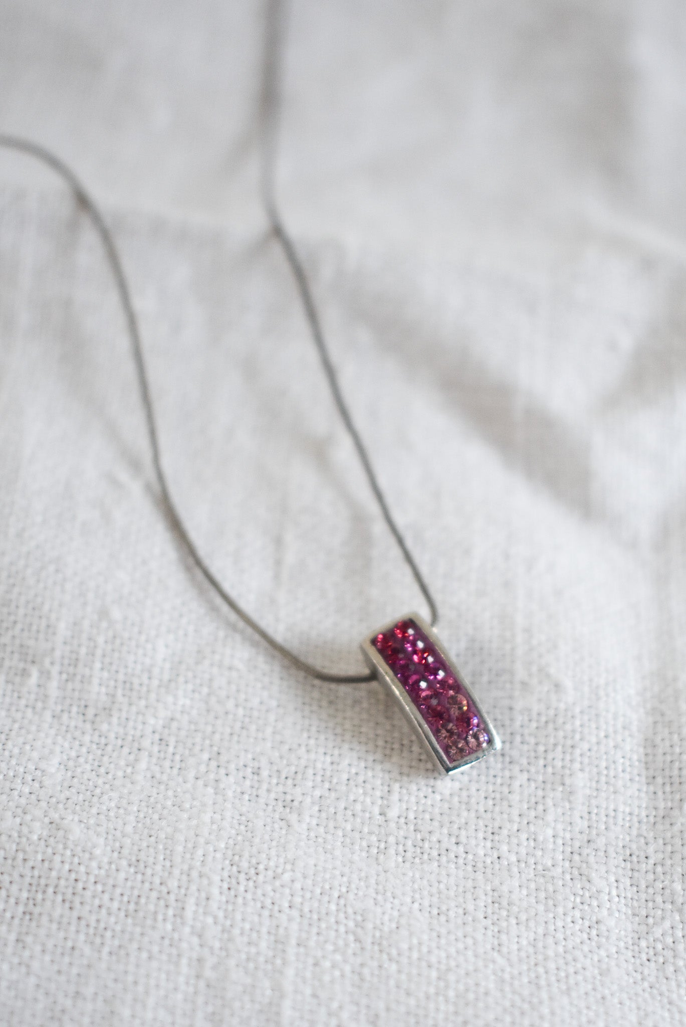 Pink sparkly pendant on silver chain