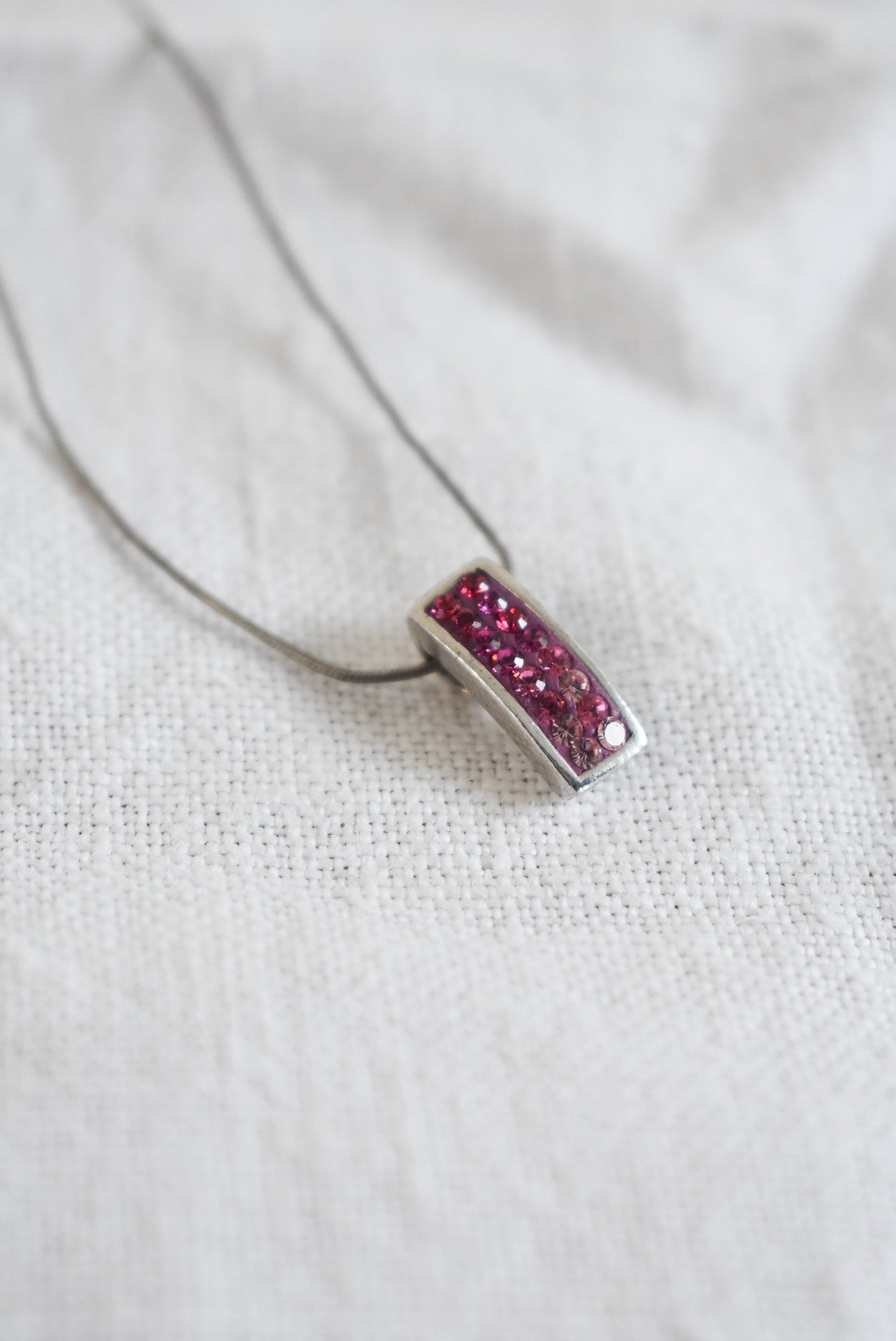 Pink sparkly pendant on silver chain