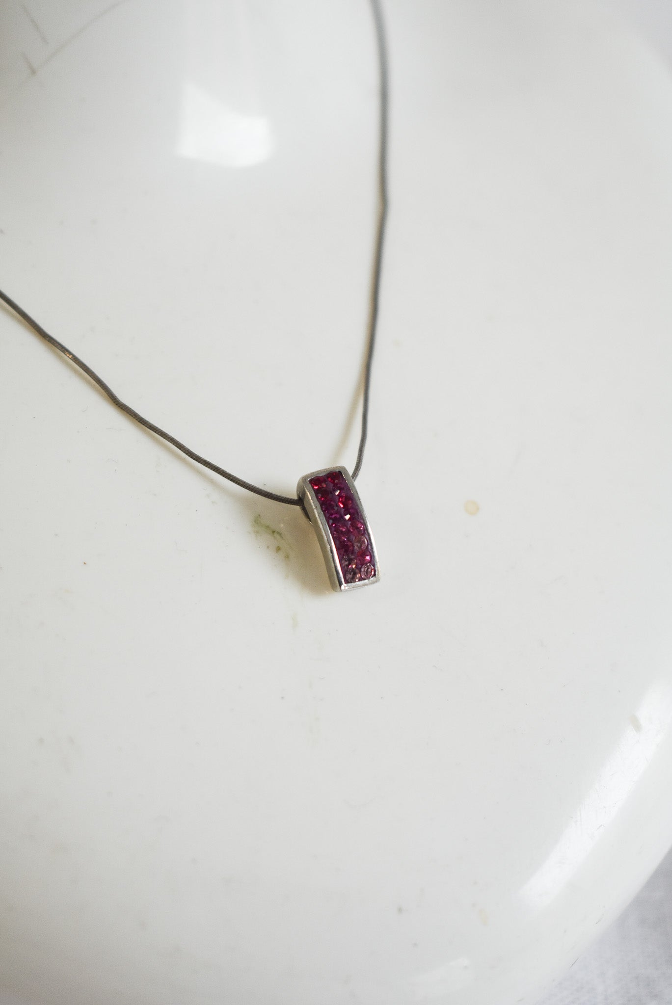 Pink sparkly pendant on silver chain