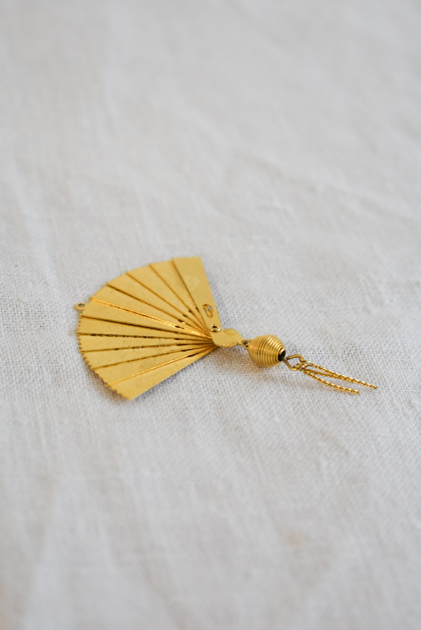 Delicate golden fan pendant