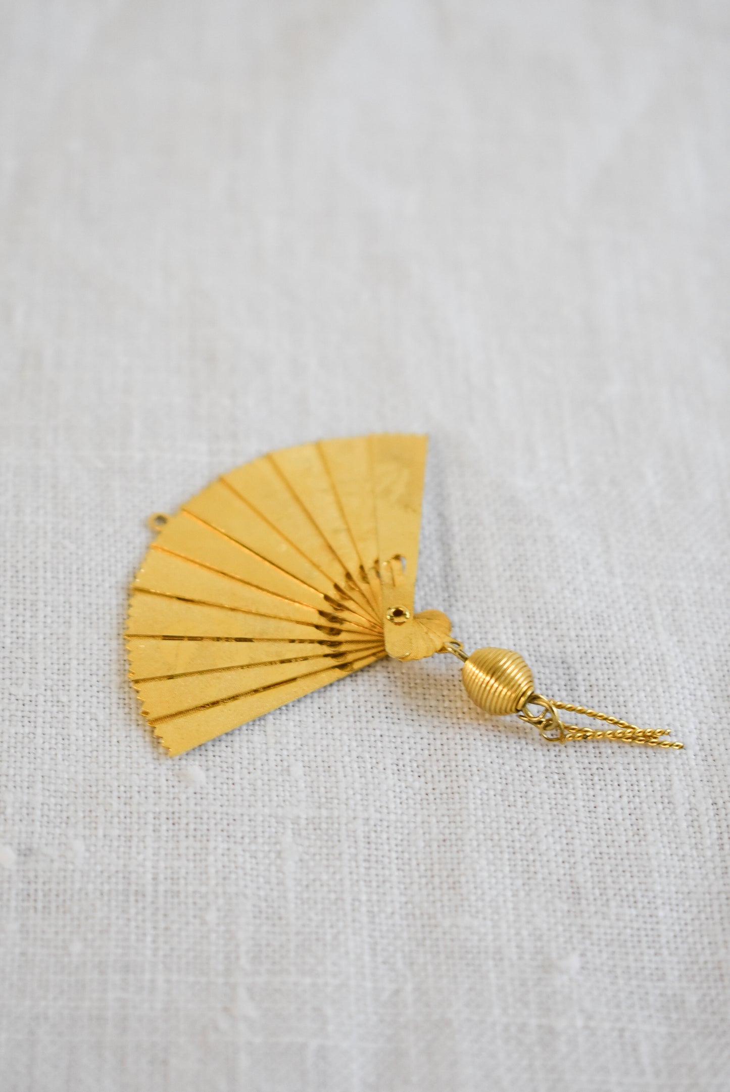 Delicate golden fan pendant