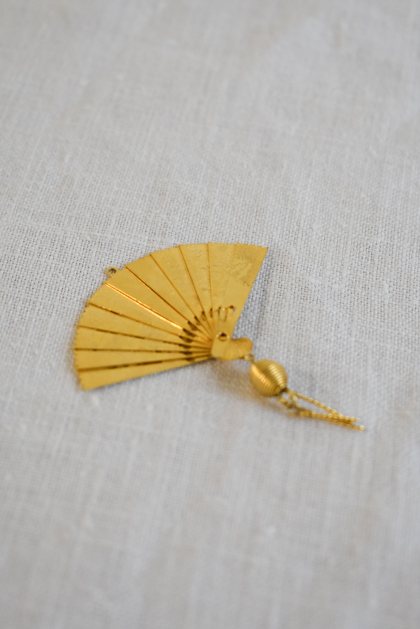 Delicate golden fan pendant