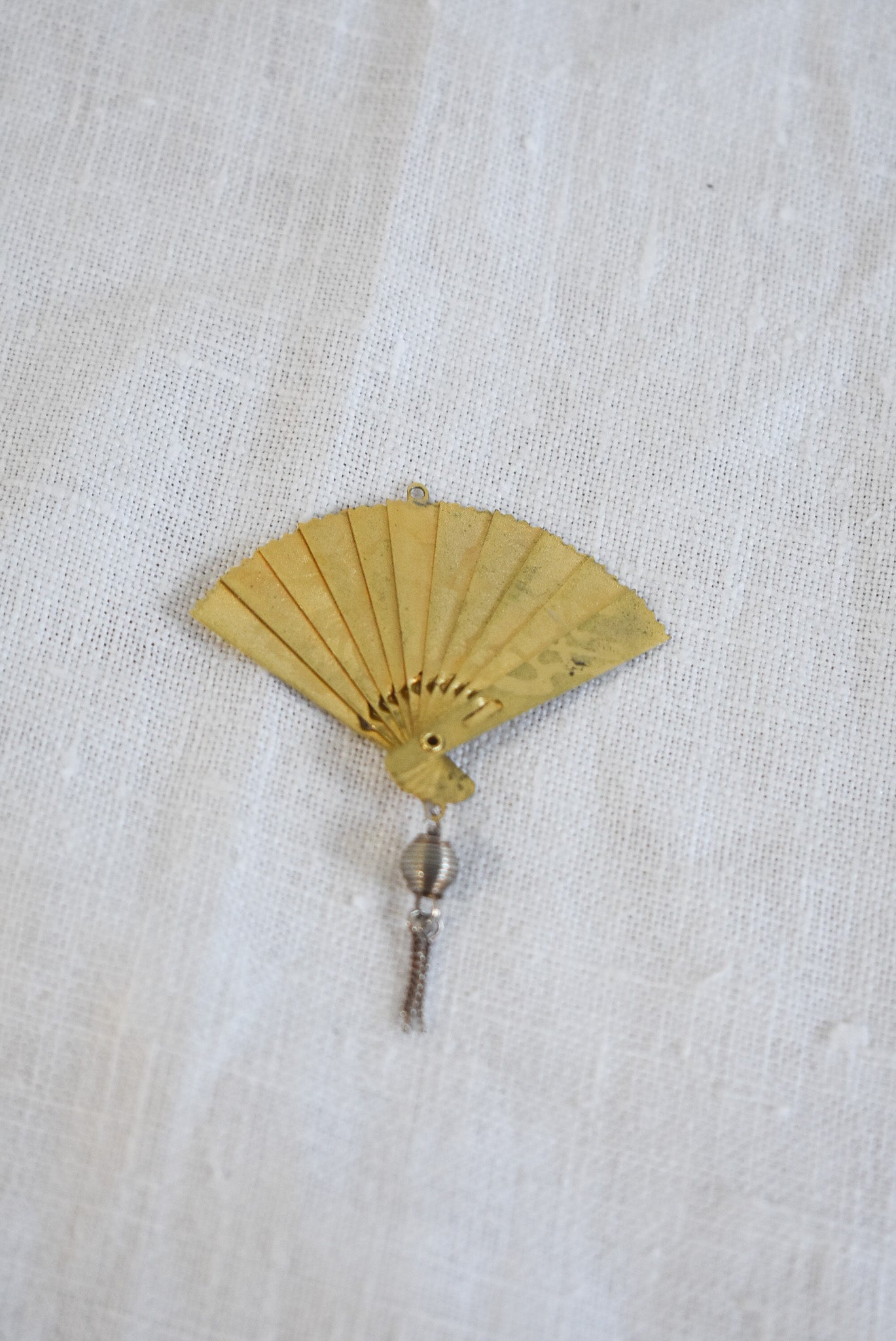 Delicate golden fan pendant