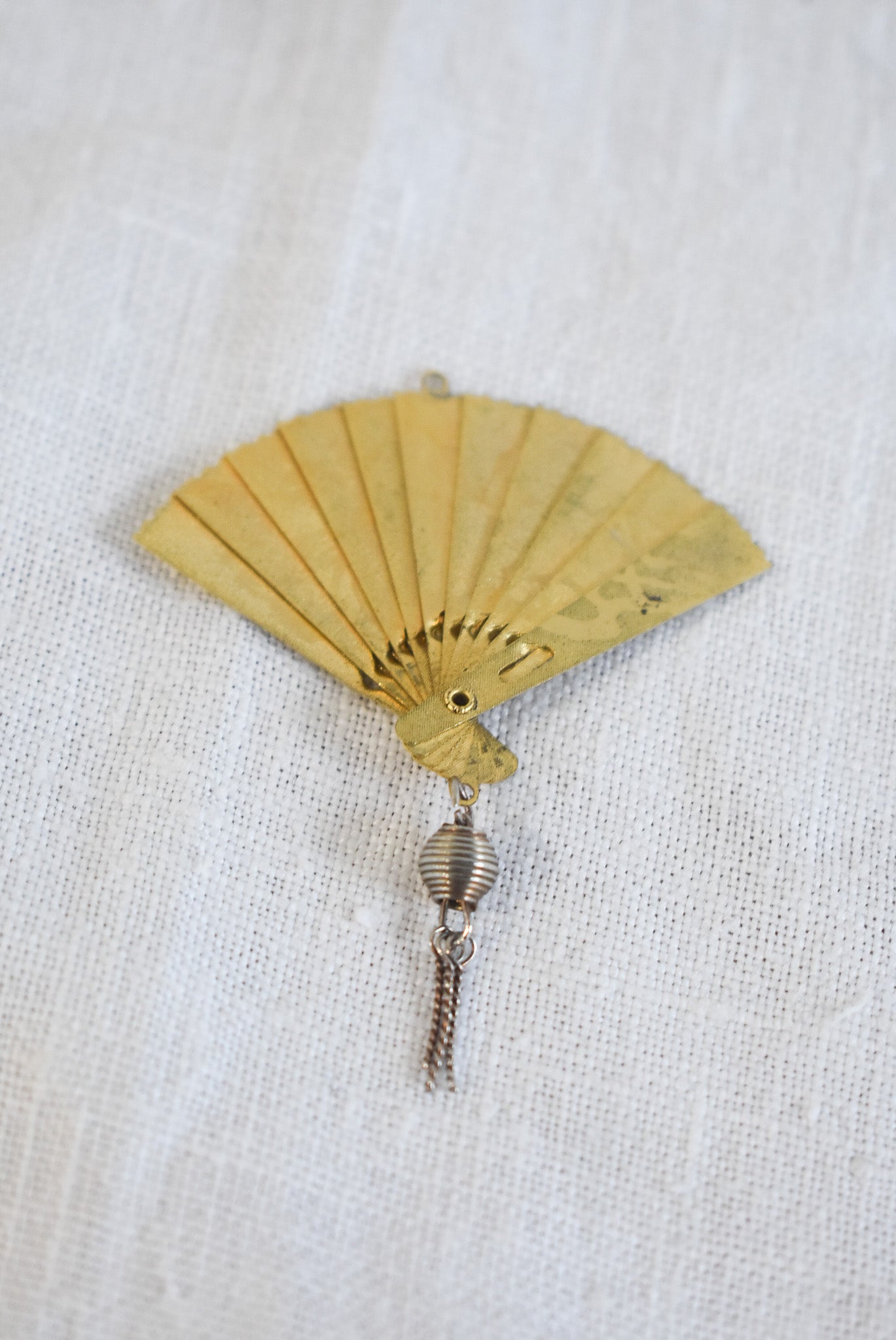 Delicate golden fan pendant