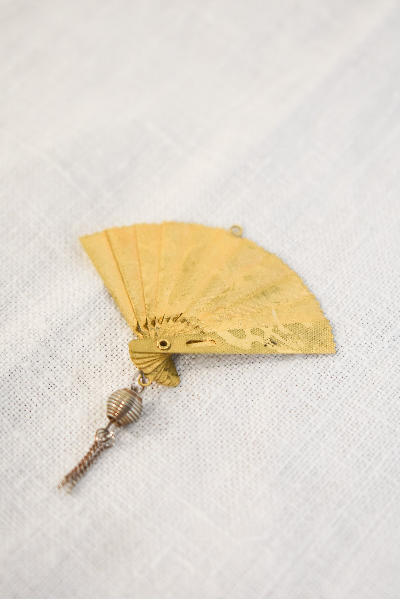 Delicate golden fan pendant