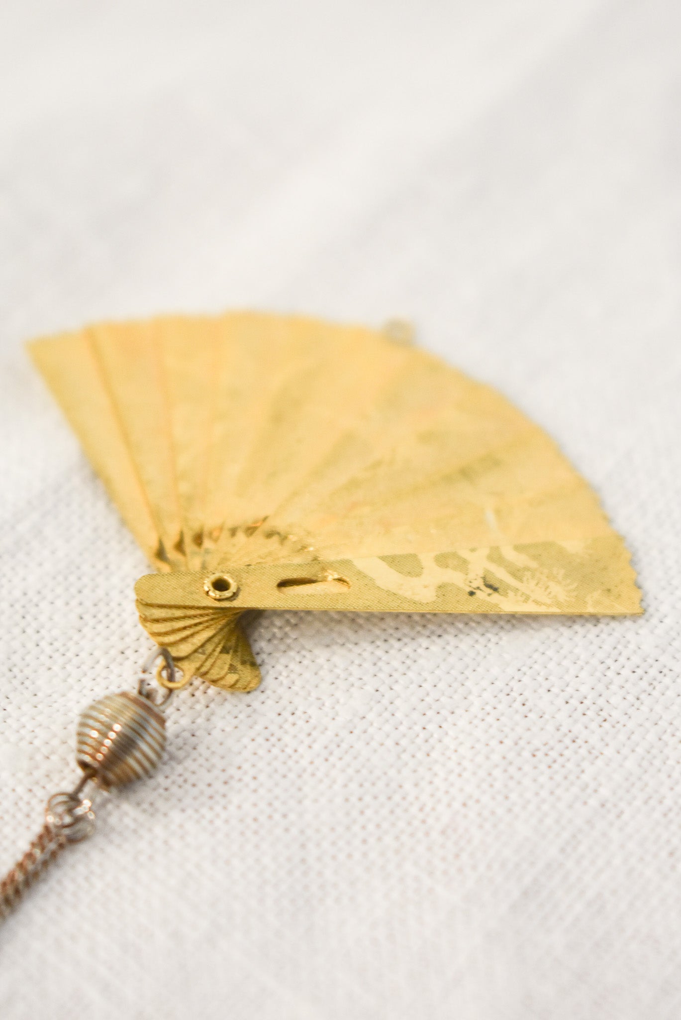 Delicate golden fan pendant