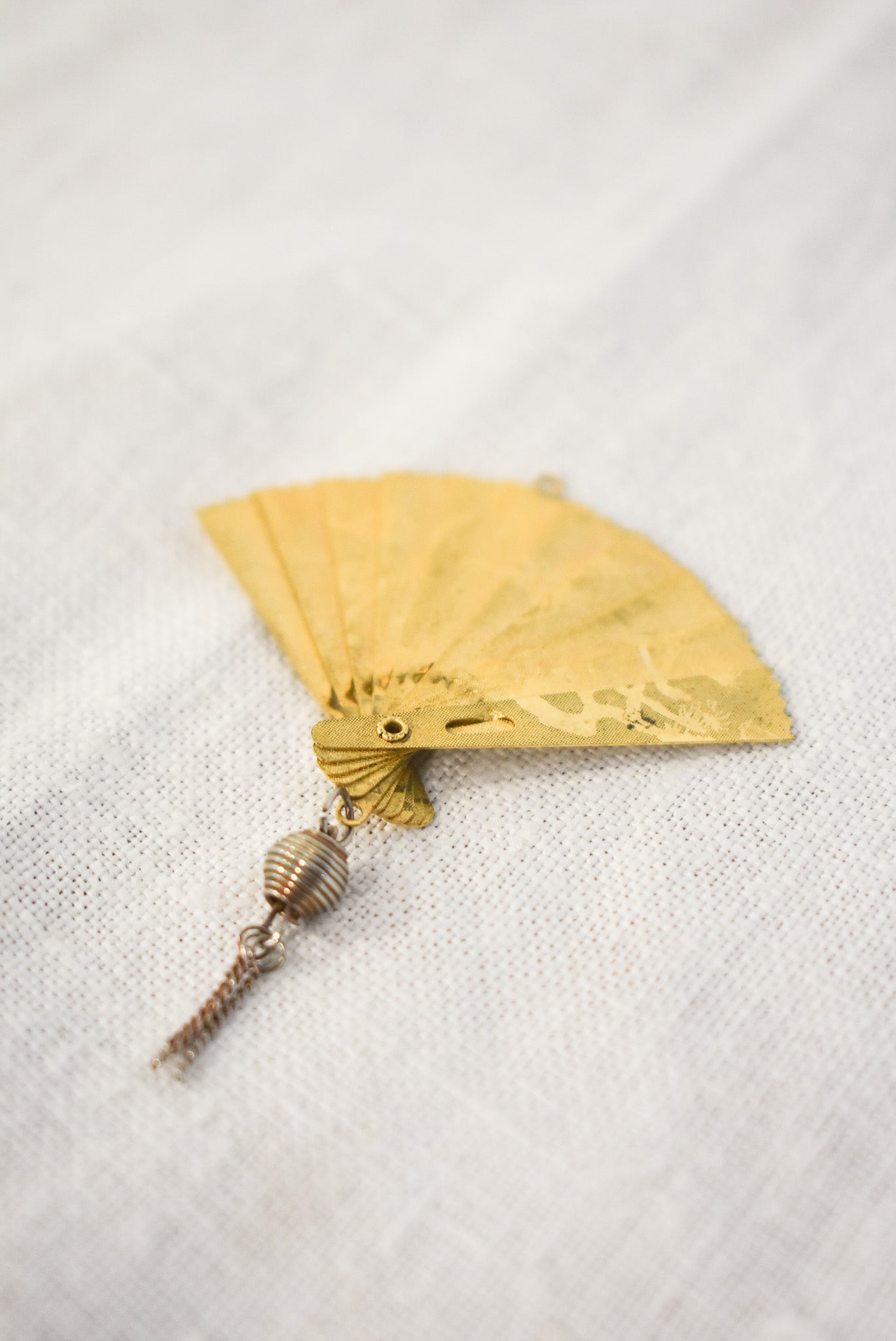 Delicate golden fan pendant