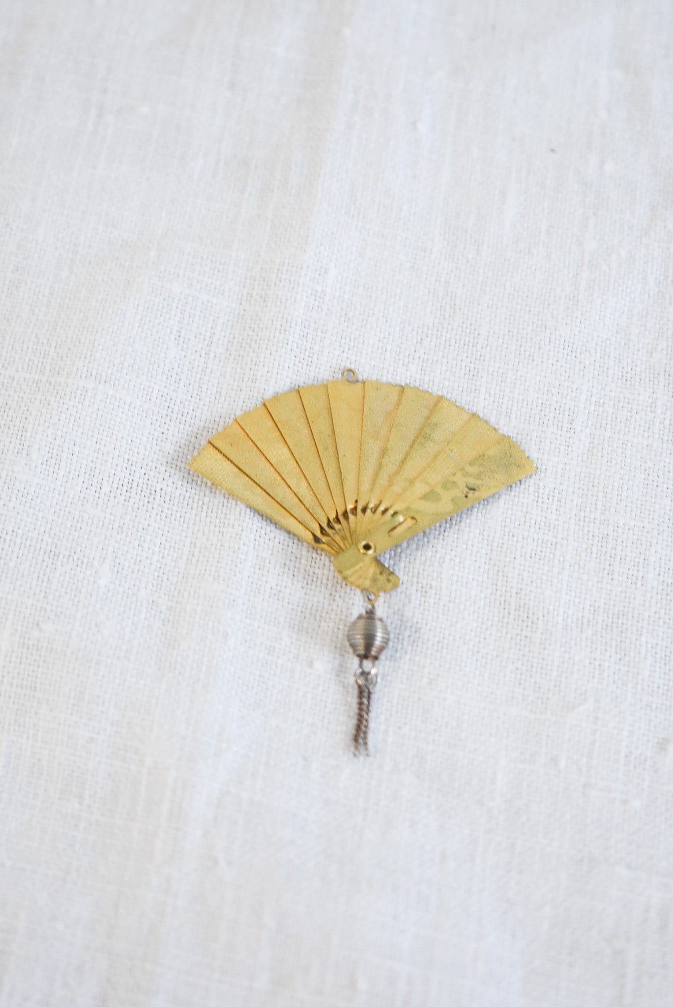 Delicate golden fan pendant