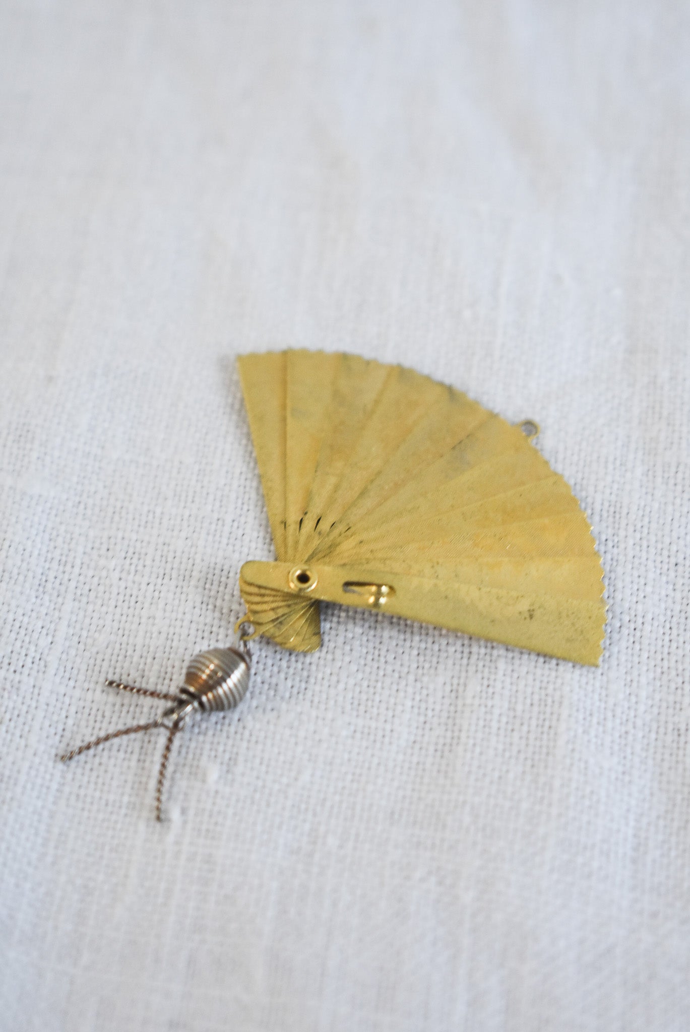 Delicate golden fan pendant