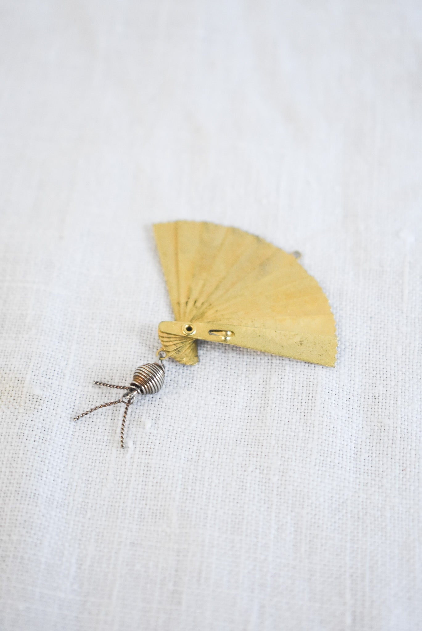 Delicate golden fan pendant