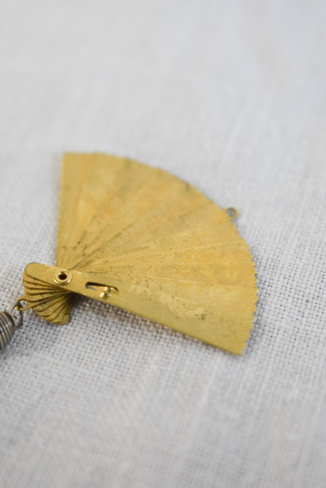 Delicate golden fan pendant