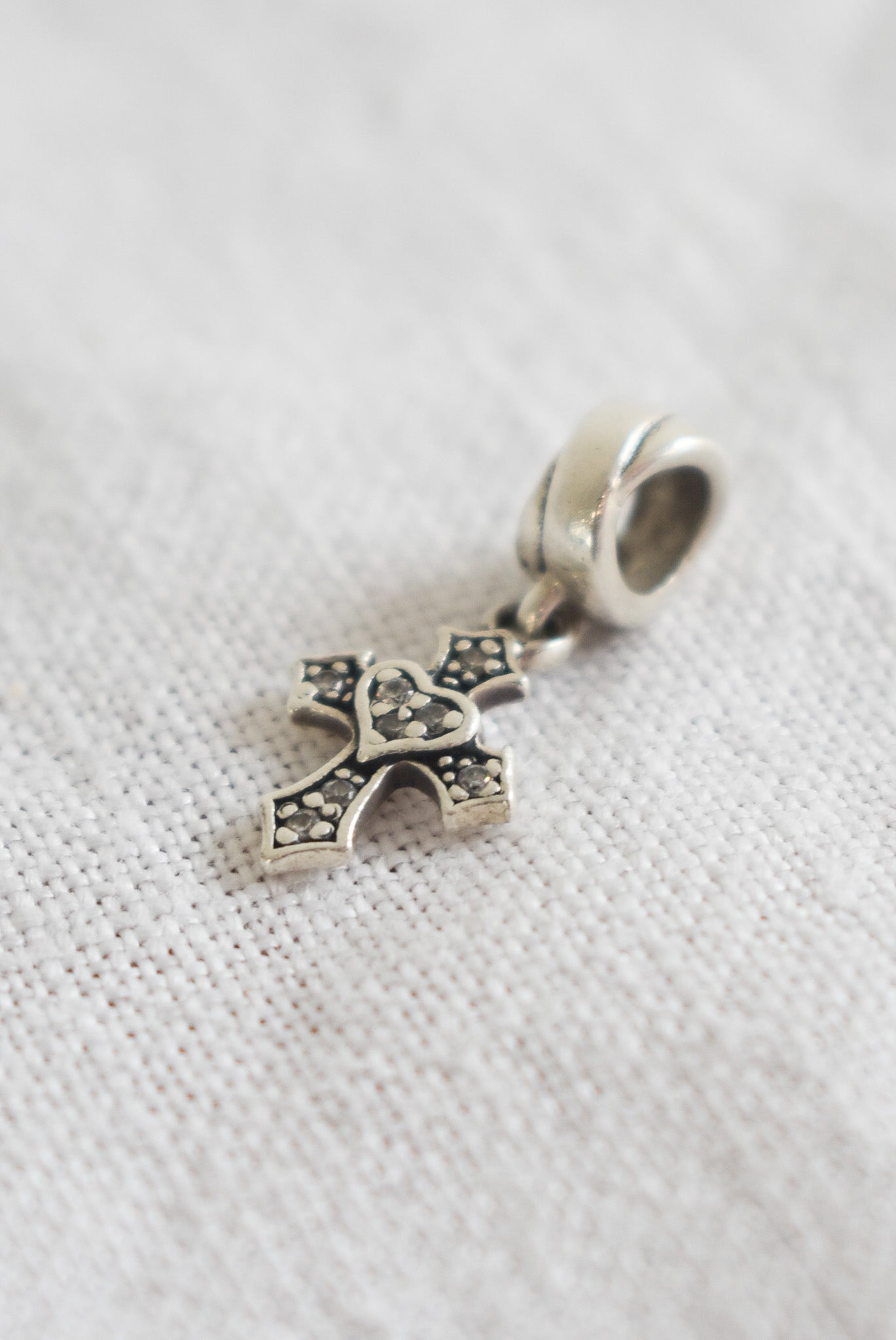 Sterling silver + diamond cross charm