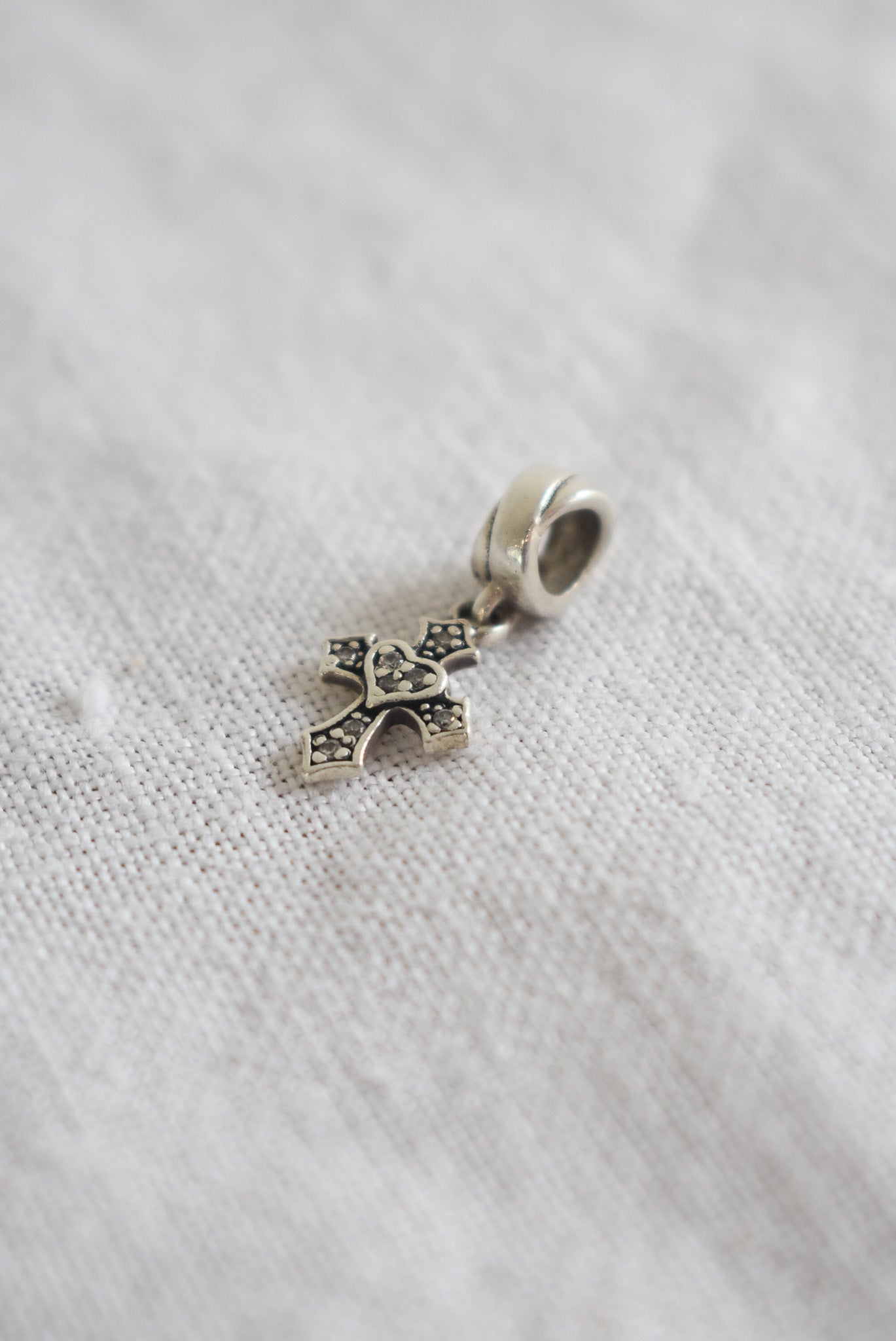 Sterling silver + diamond cross charm