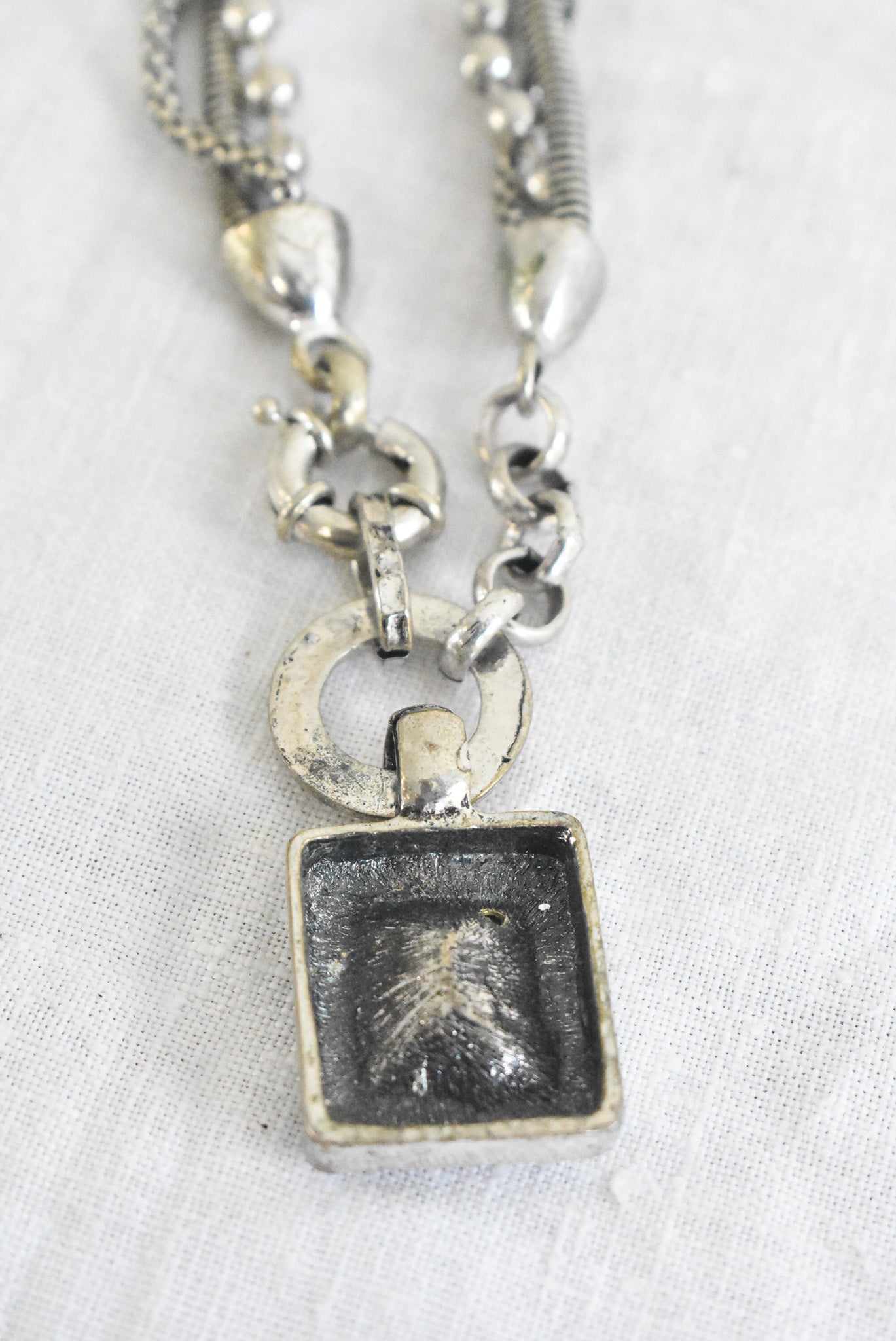 Chunky silver "heavy metal" necklace with square glass pendant