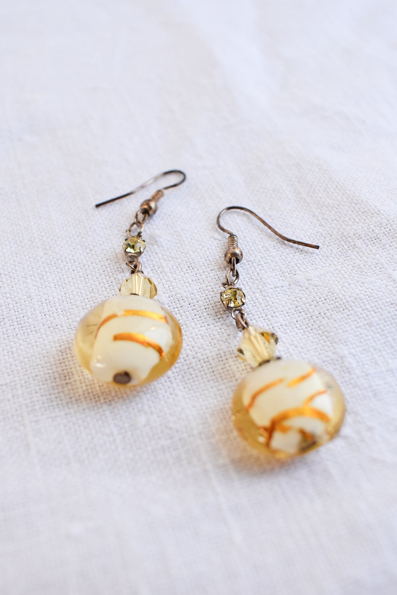 Dangly glass bead gold coloured earrings