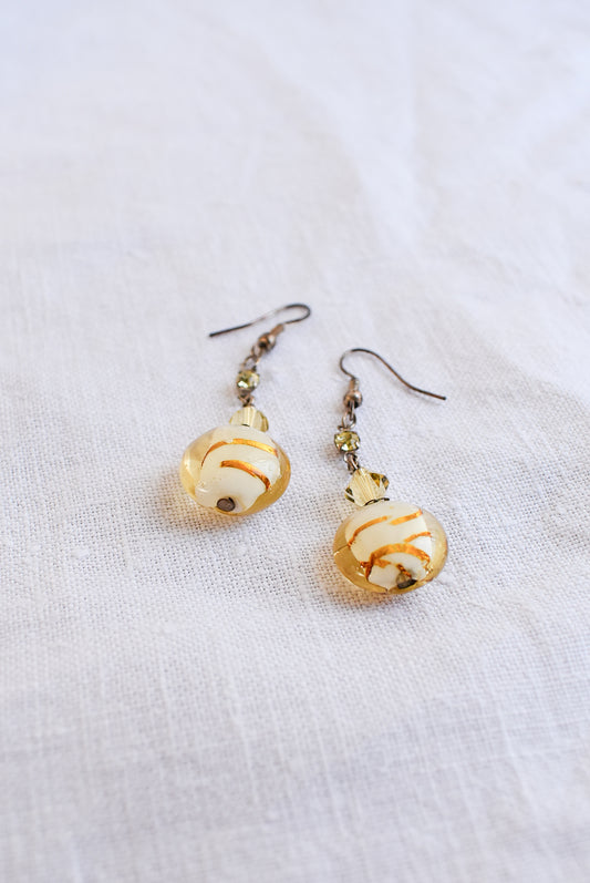 Dangly glass bead gold coloured earrings