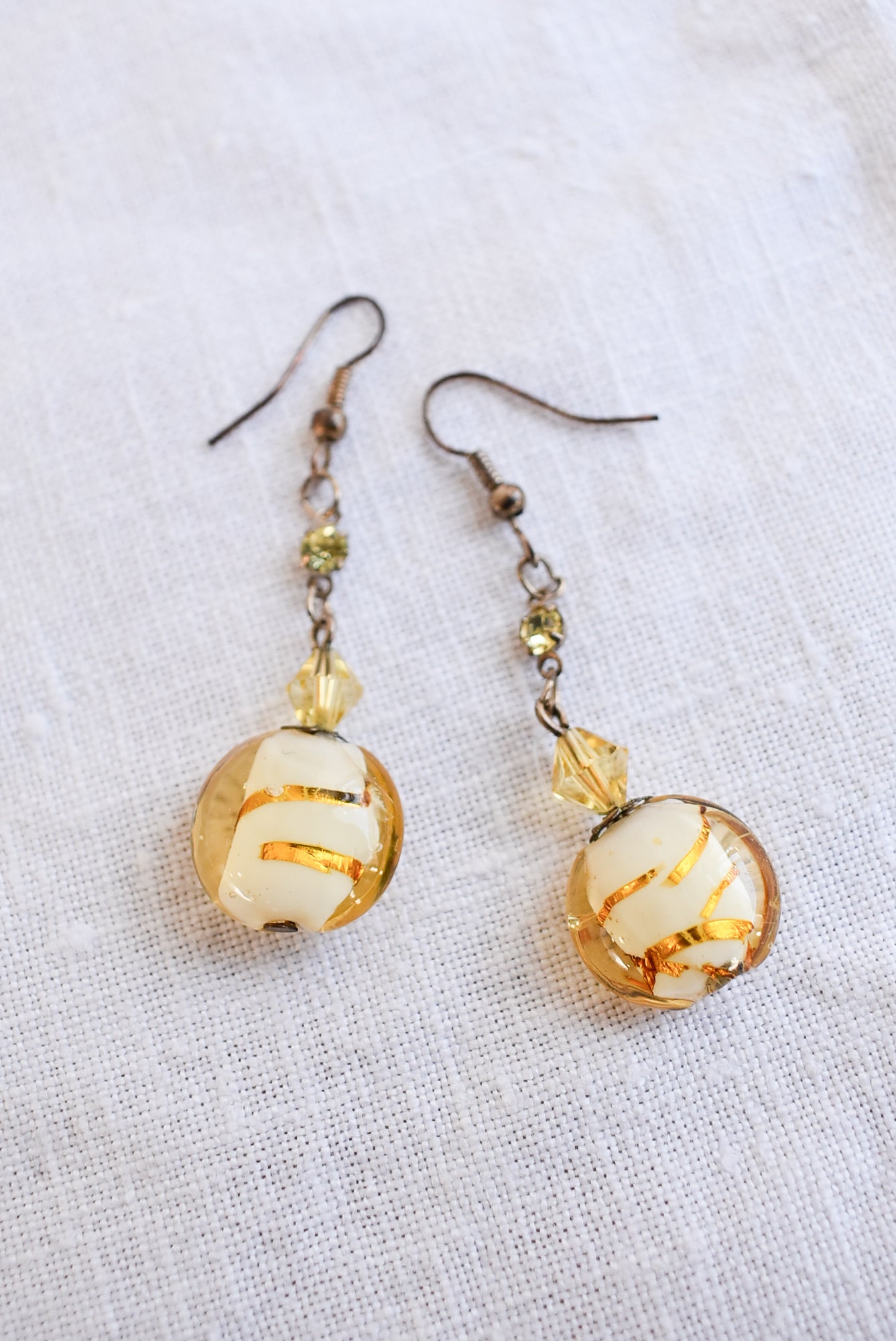 Dangly glass bead gold coloured earrings