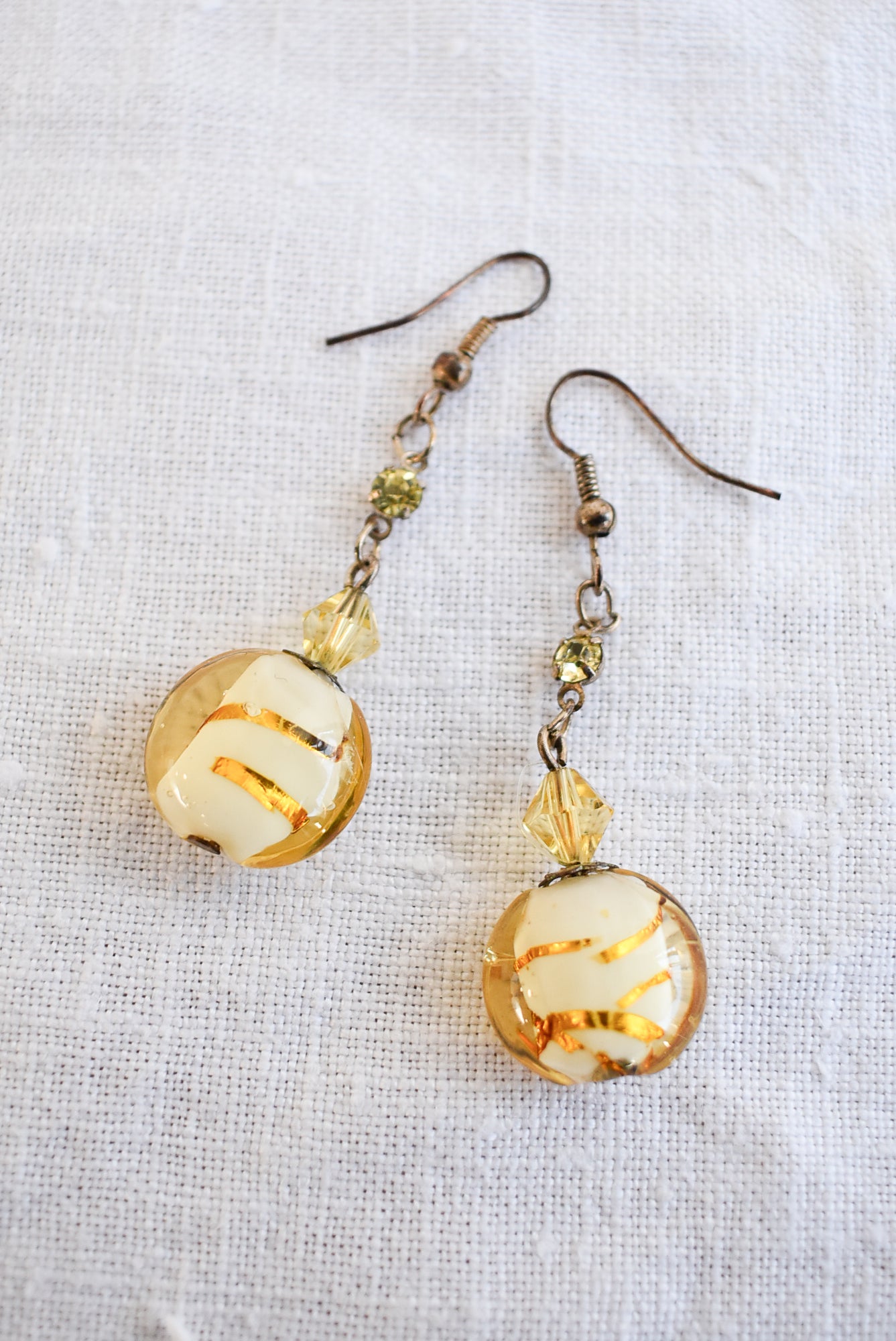 Dangly glass bead gold coloured earrings