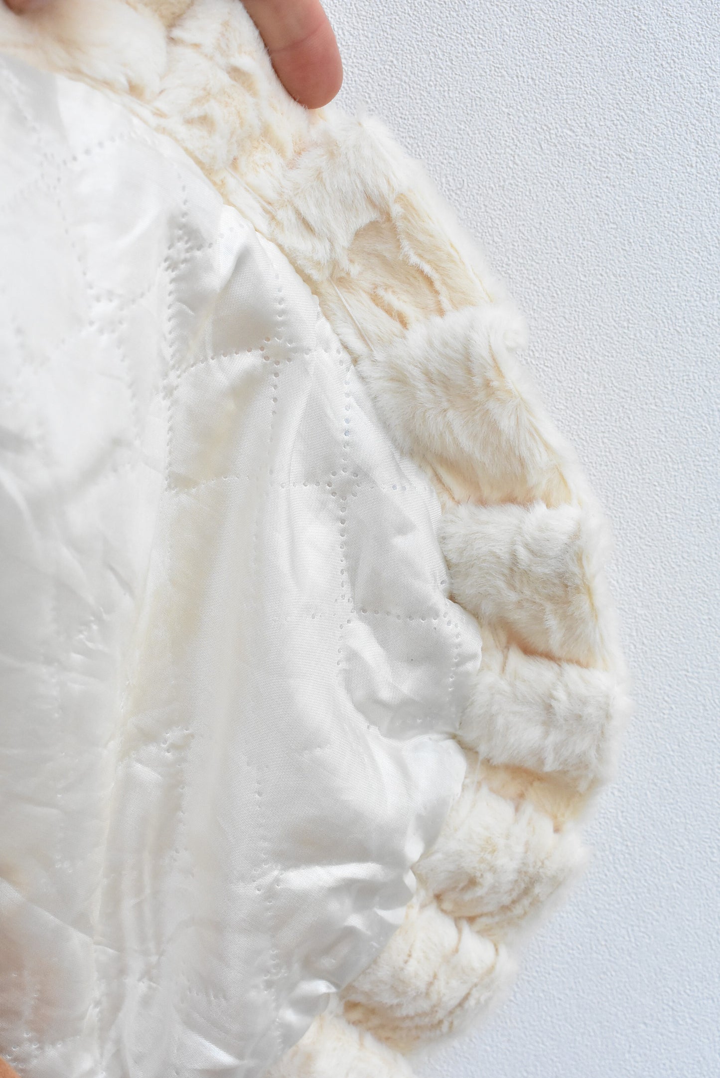 Homemade white faux-fur beaded vest