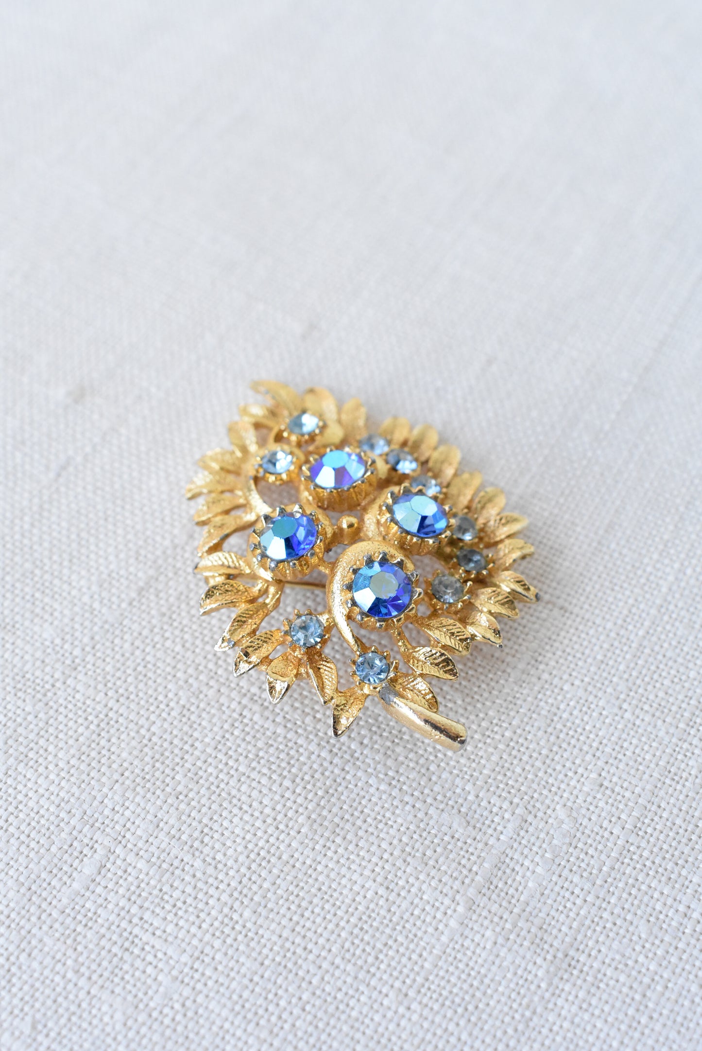 Vintage golden + blue gems brooch