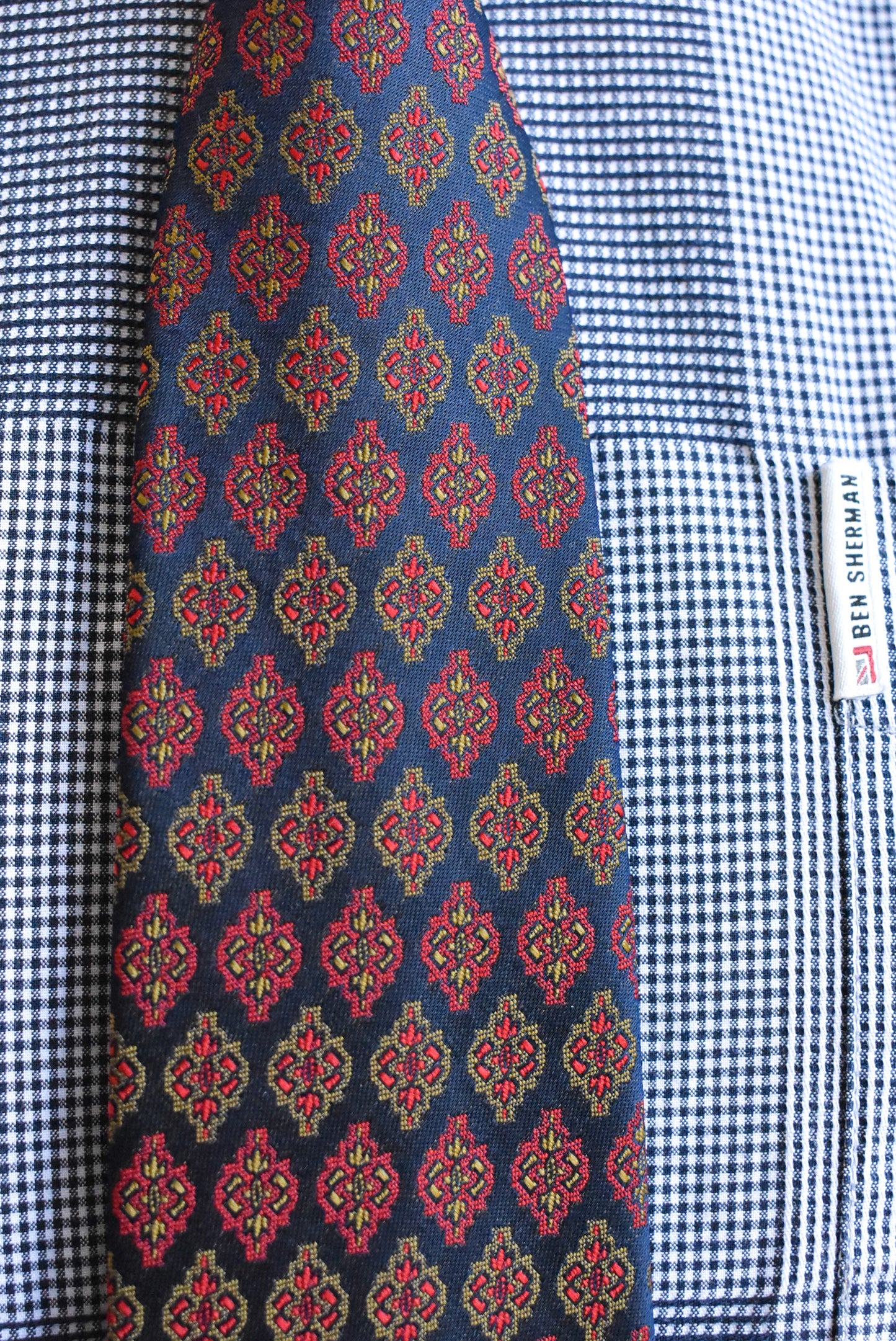 Eskay tie navy with gold and red pattern