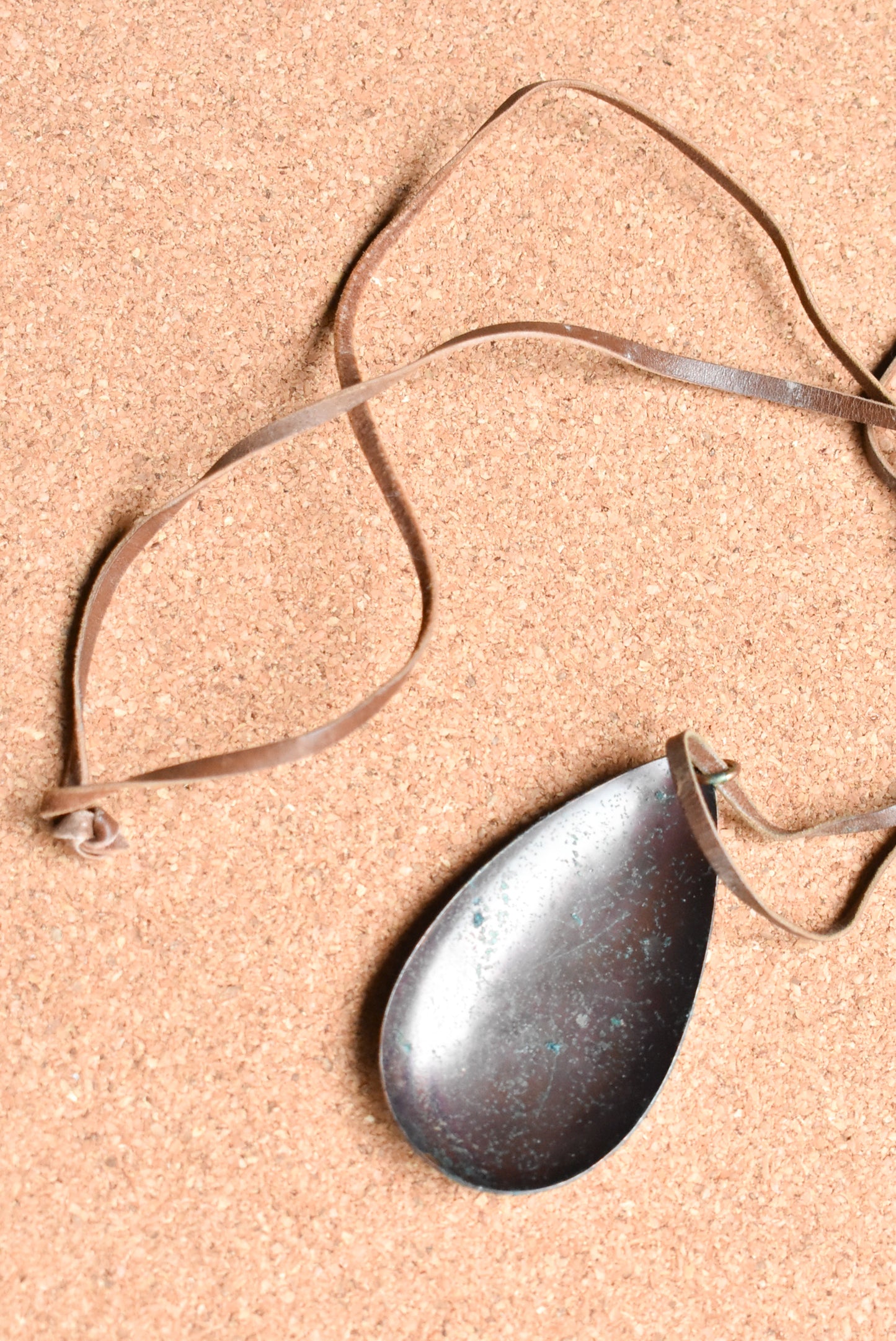 Copper teardrop necklace with leather strap.