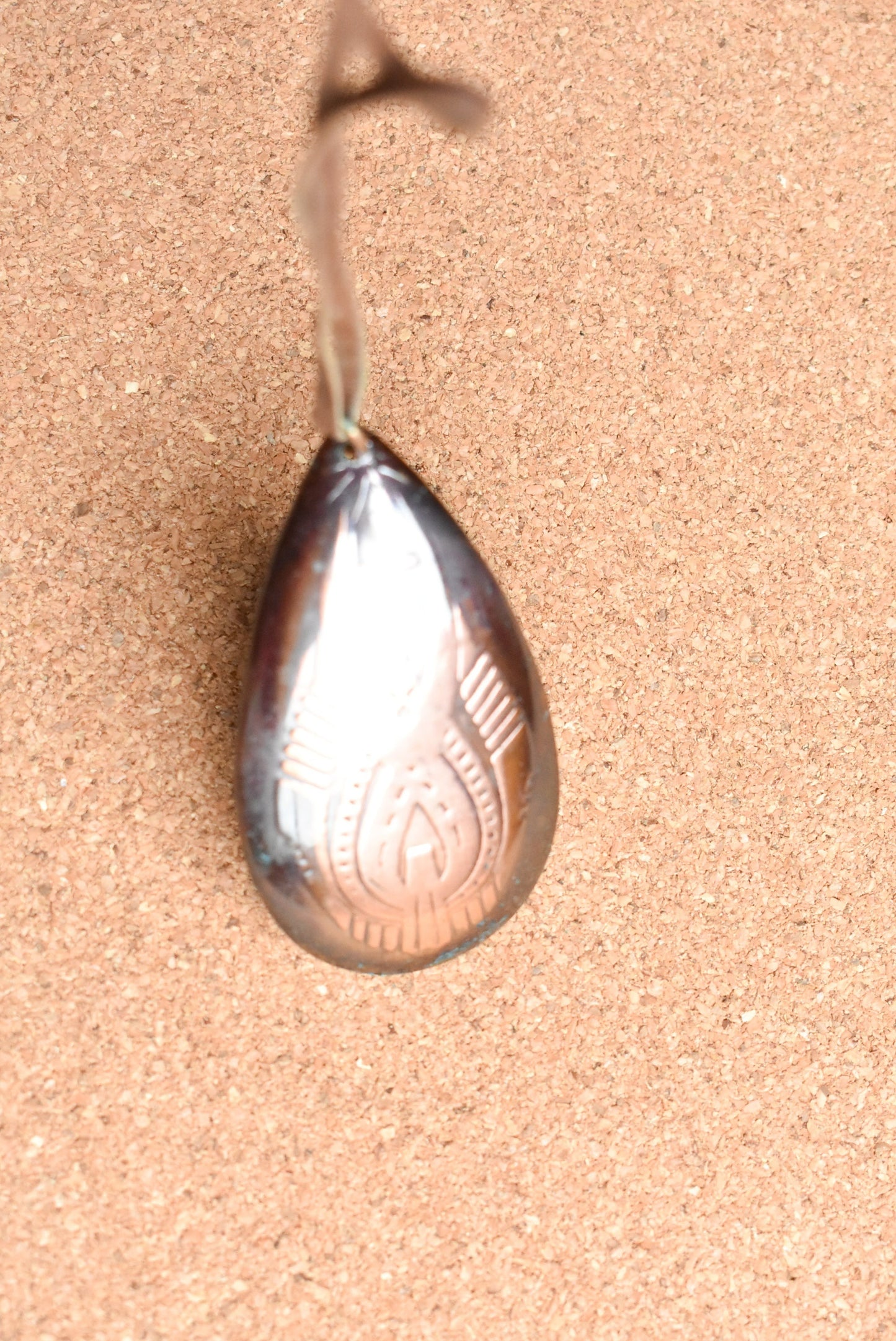 Copper teardrop necklace with leather strap.