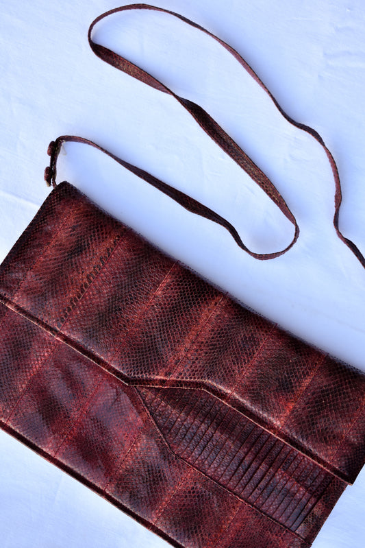 Maroon snakeskin clutch with strap