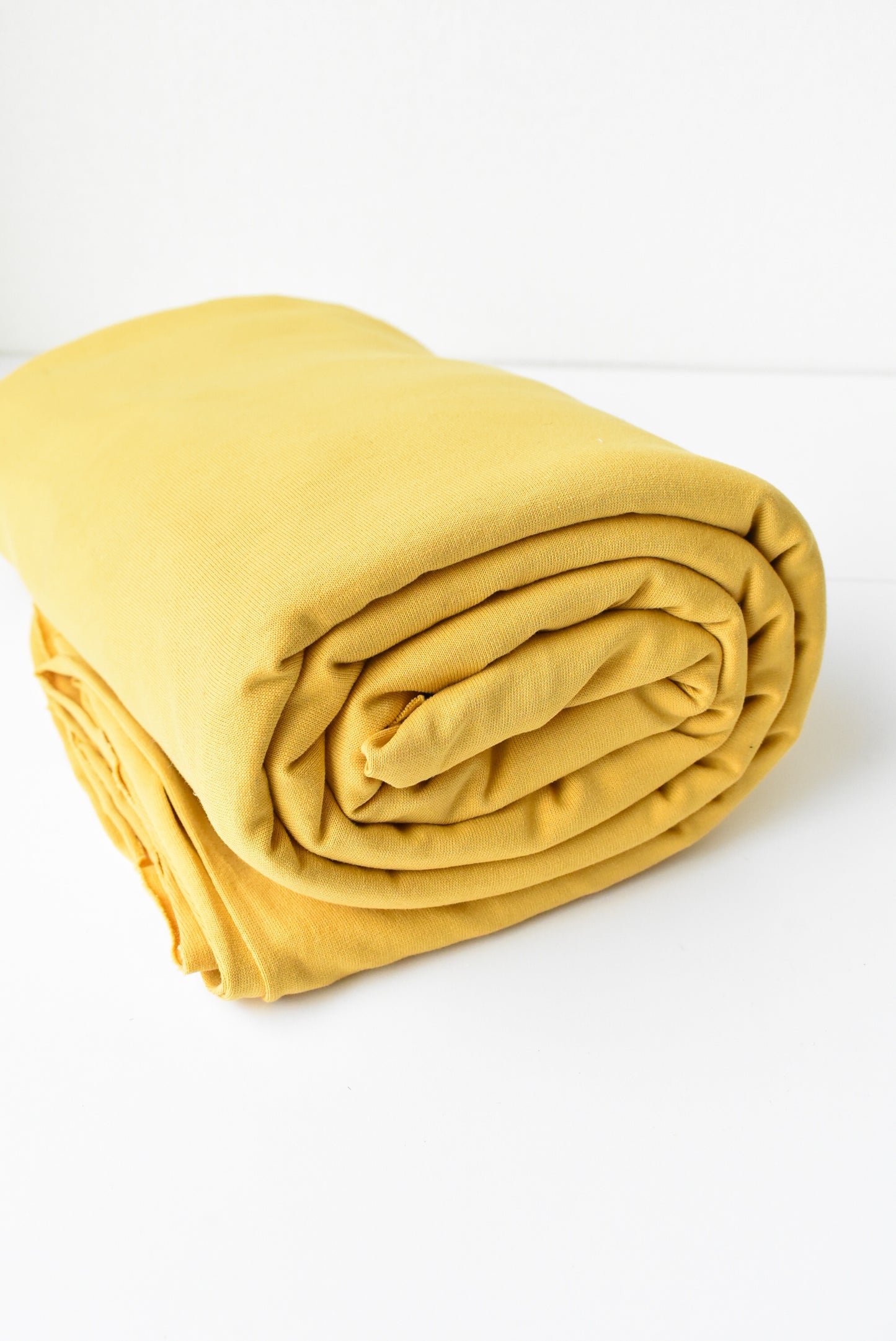 Roll of golden yellow fabric